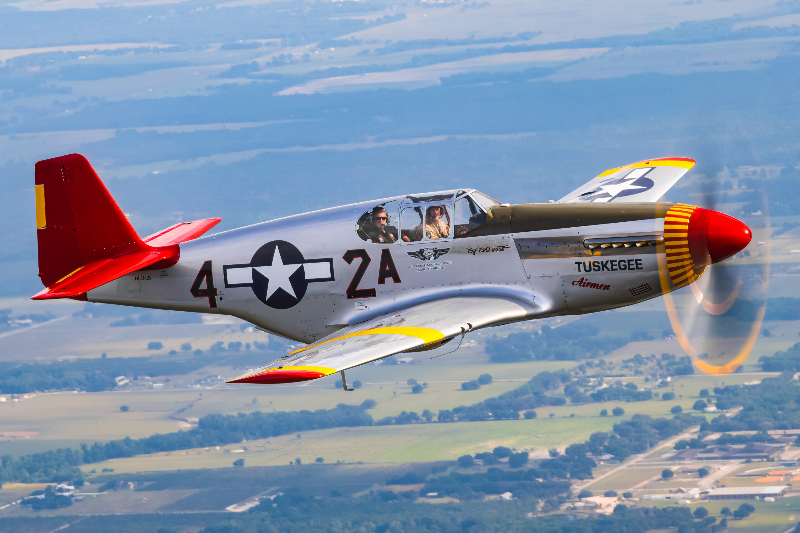 Red-tailed P-51C Mustang in Tuskegee Airmen colours flying air to air