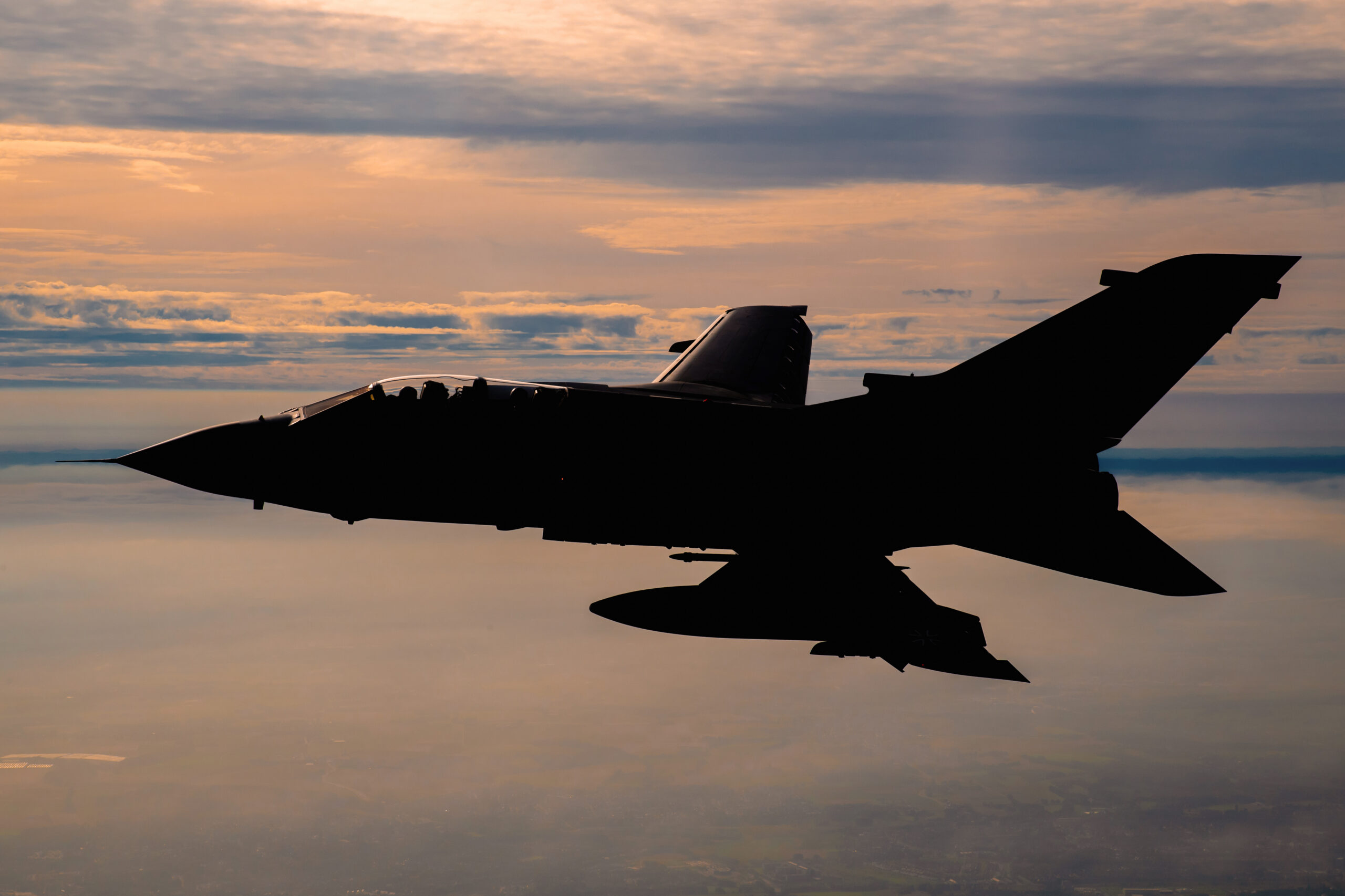 Panavia Tornado in crisp silhouette against an orange dusk sky