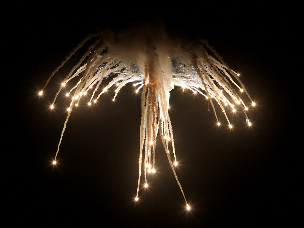 RAAF C-130J-30 Hercules trailing flares during a night-time display at Avalon