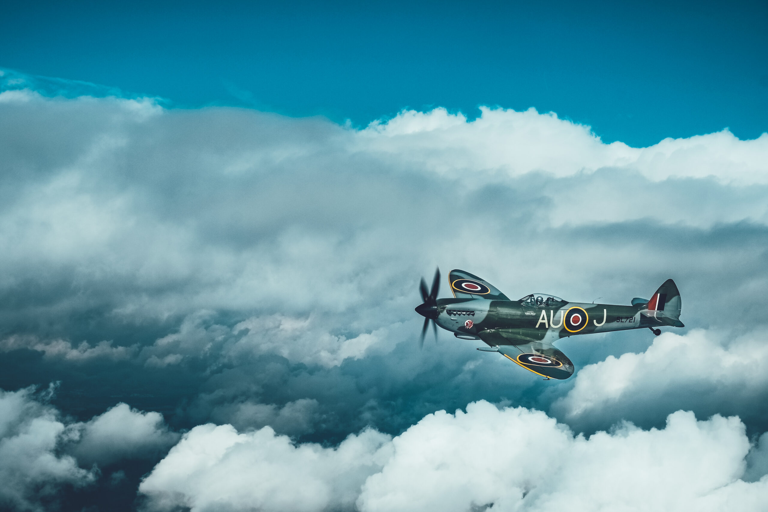 Supermarine Spitfire LF16E SL721 AU-J flying between towering clouds
