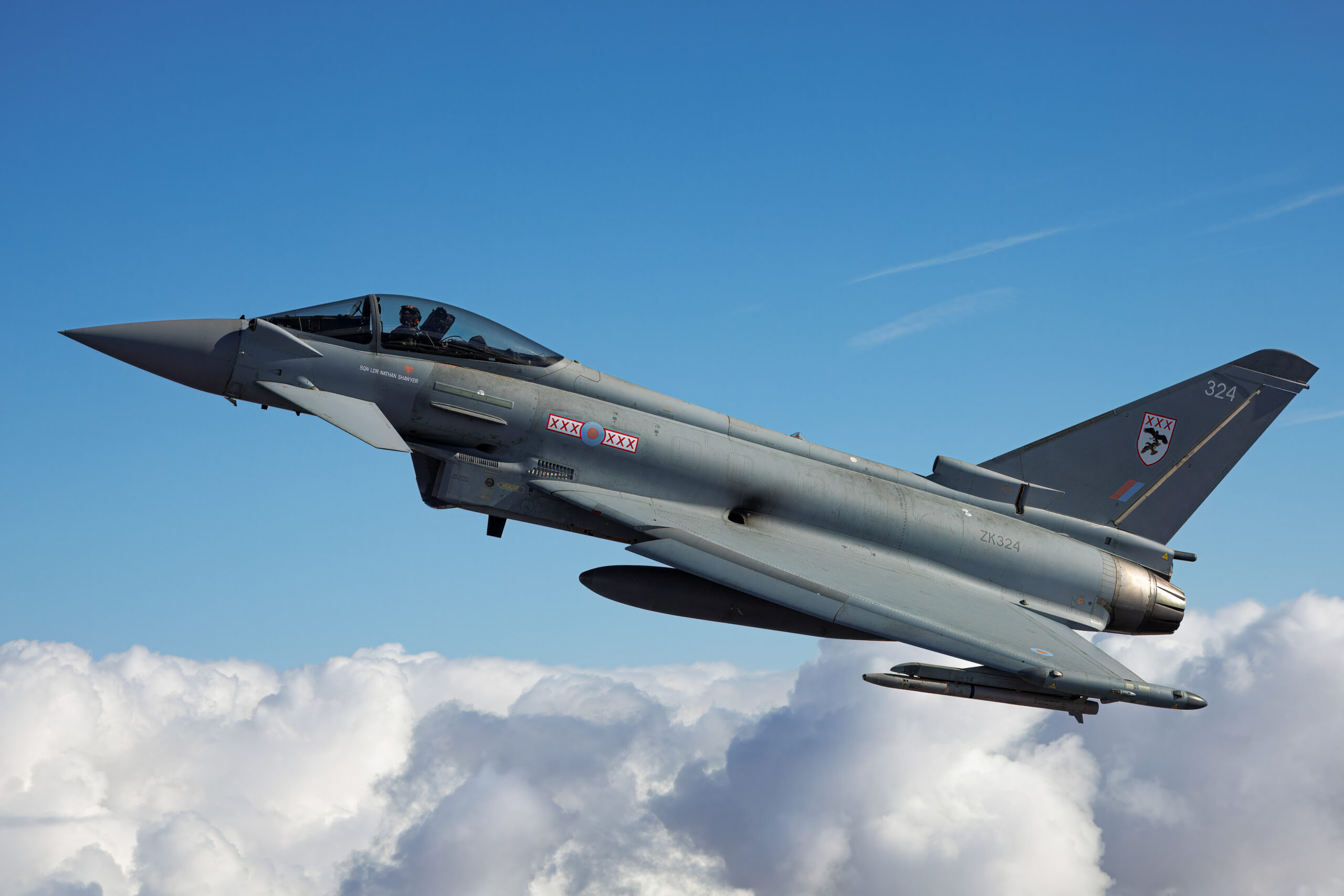 RAF Eurofighter Typhoon FGR4 ZK324 of 29 Squadron in side profile above towering cumulus cloud, pilot visible under the canopy