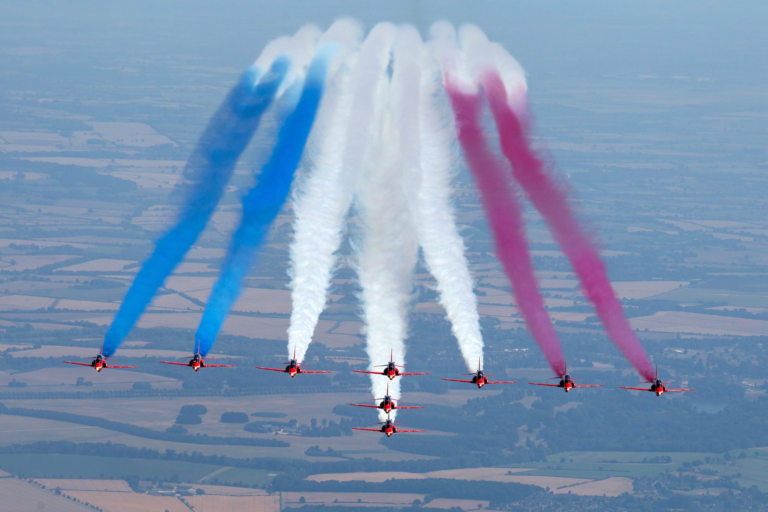 Red Arrows Hawk T1 jets breaking apart with red, white and blue smoke