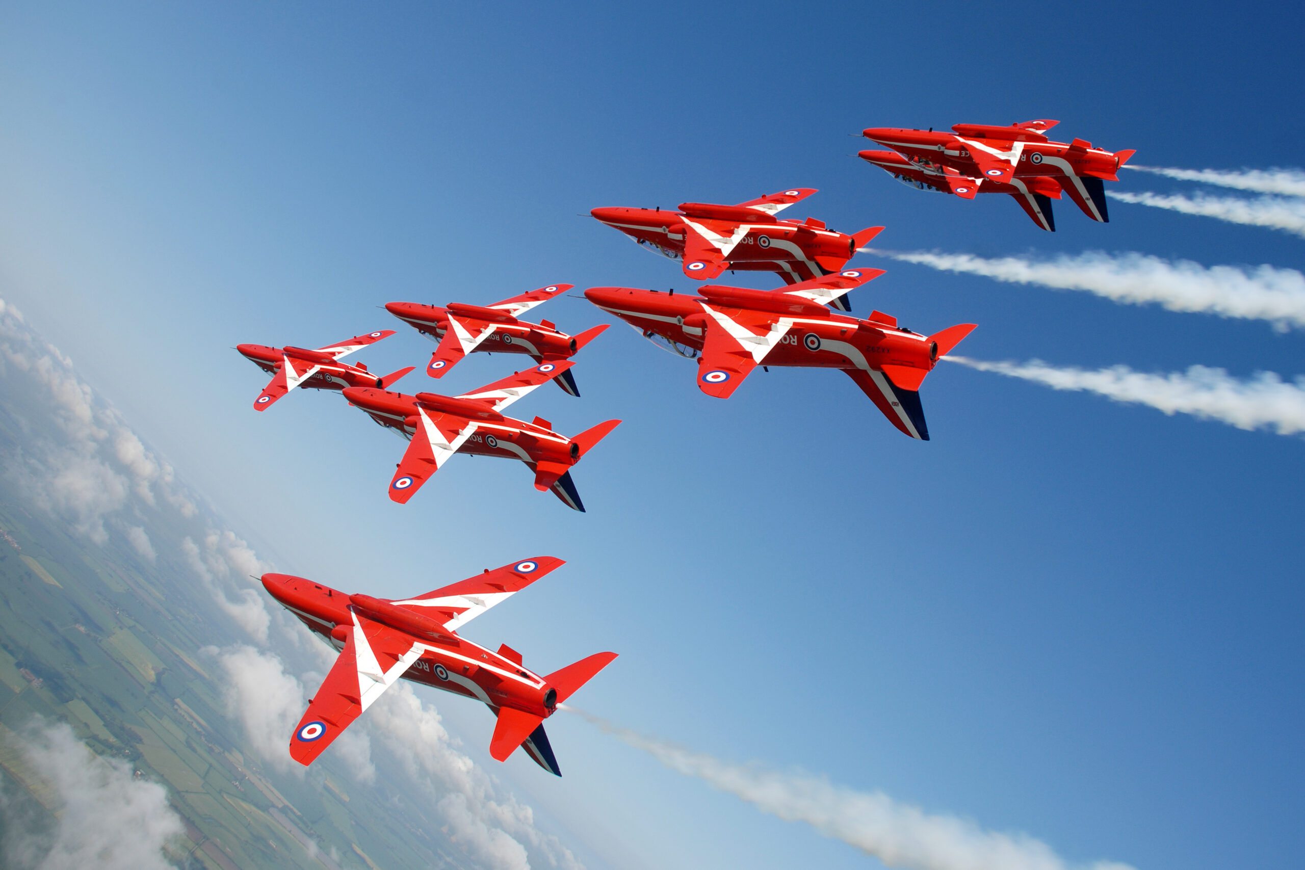 The Red Arrows rolling inverted in tight formation during display training
