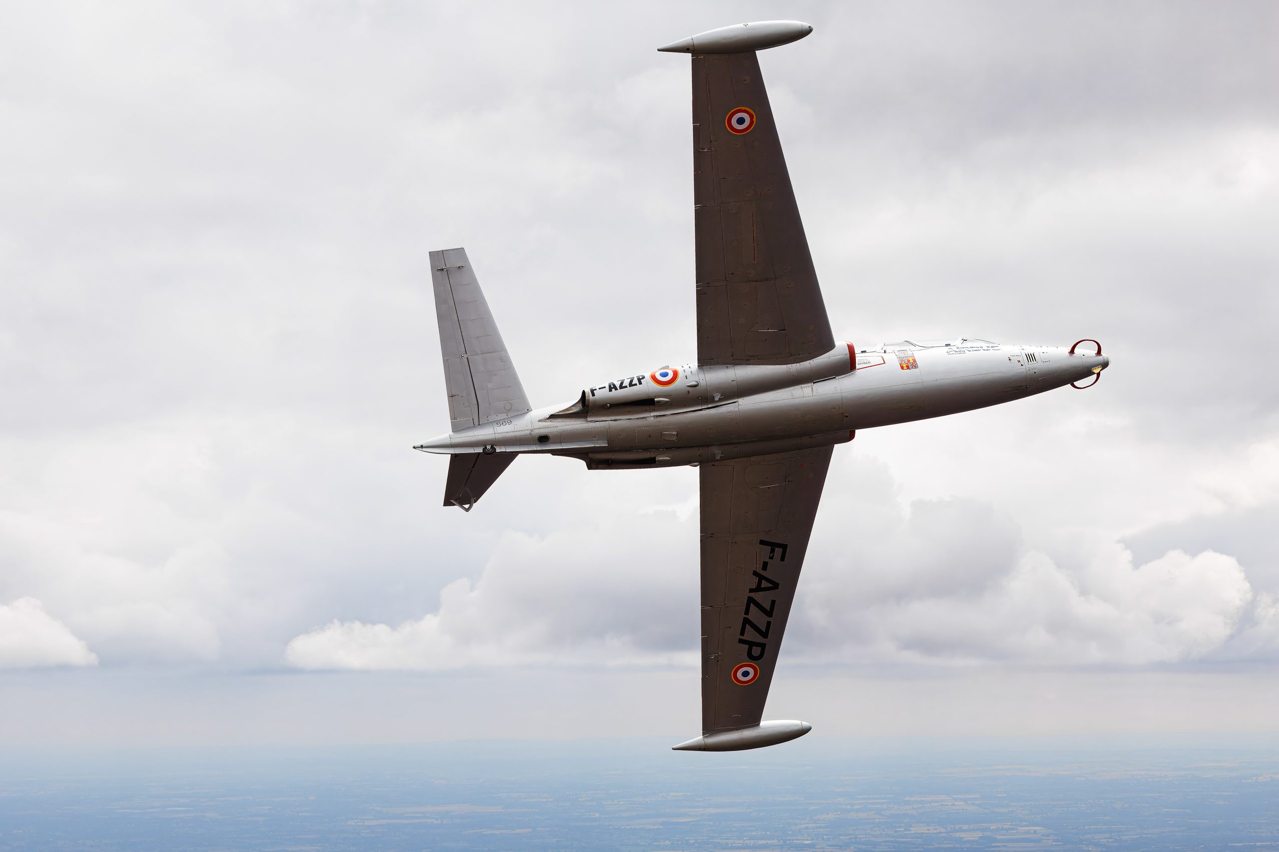 French Fouga CM-170 Magister jet trainer topside against cloud