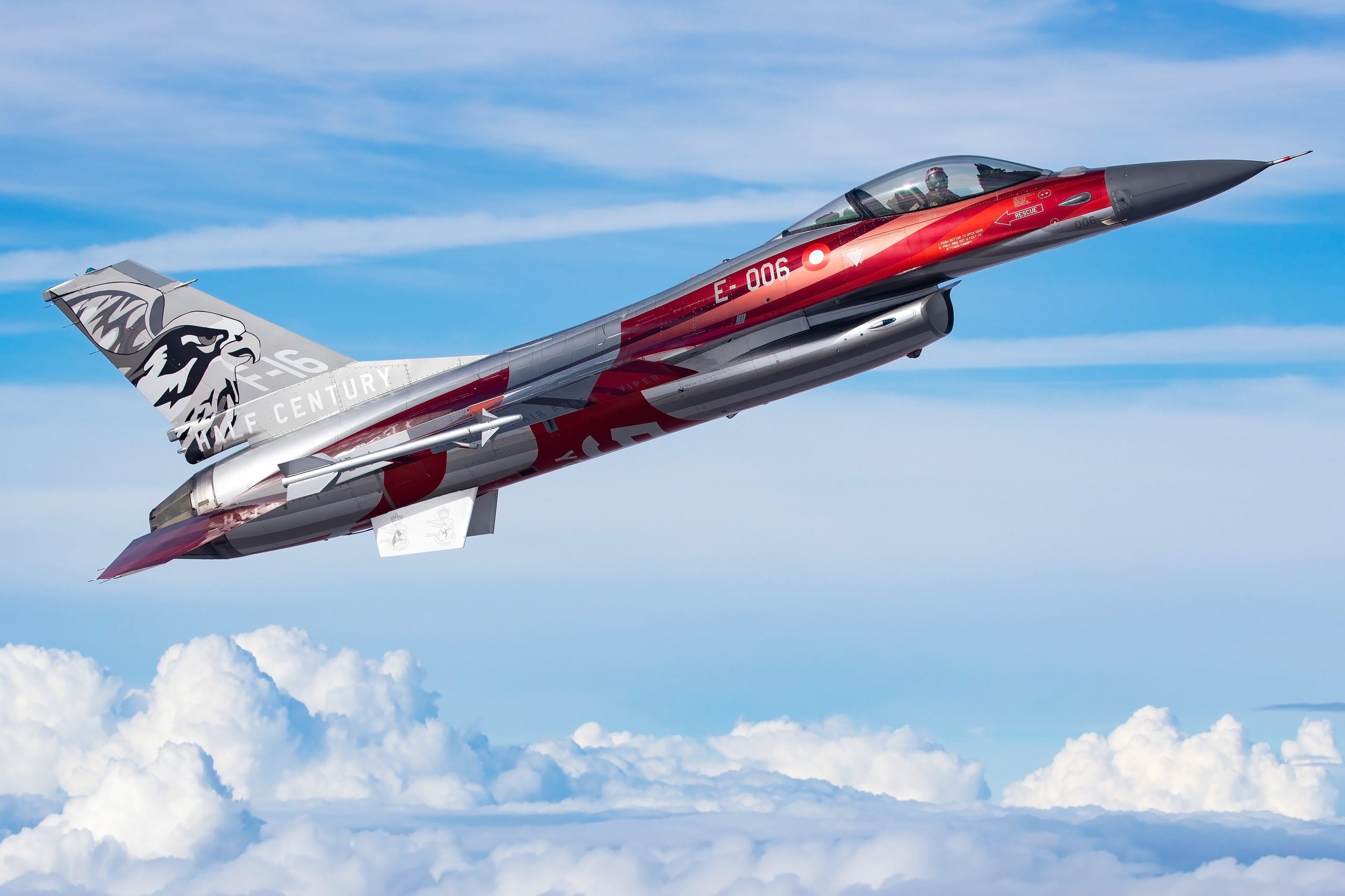 Royal Danish Air Force F-16AM banking in strong sunlight above cloud at RIAT 2025