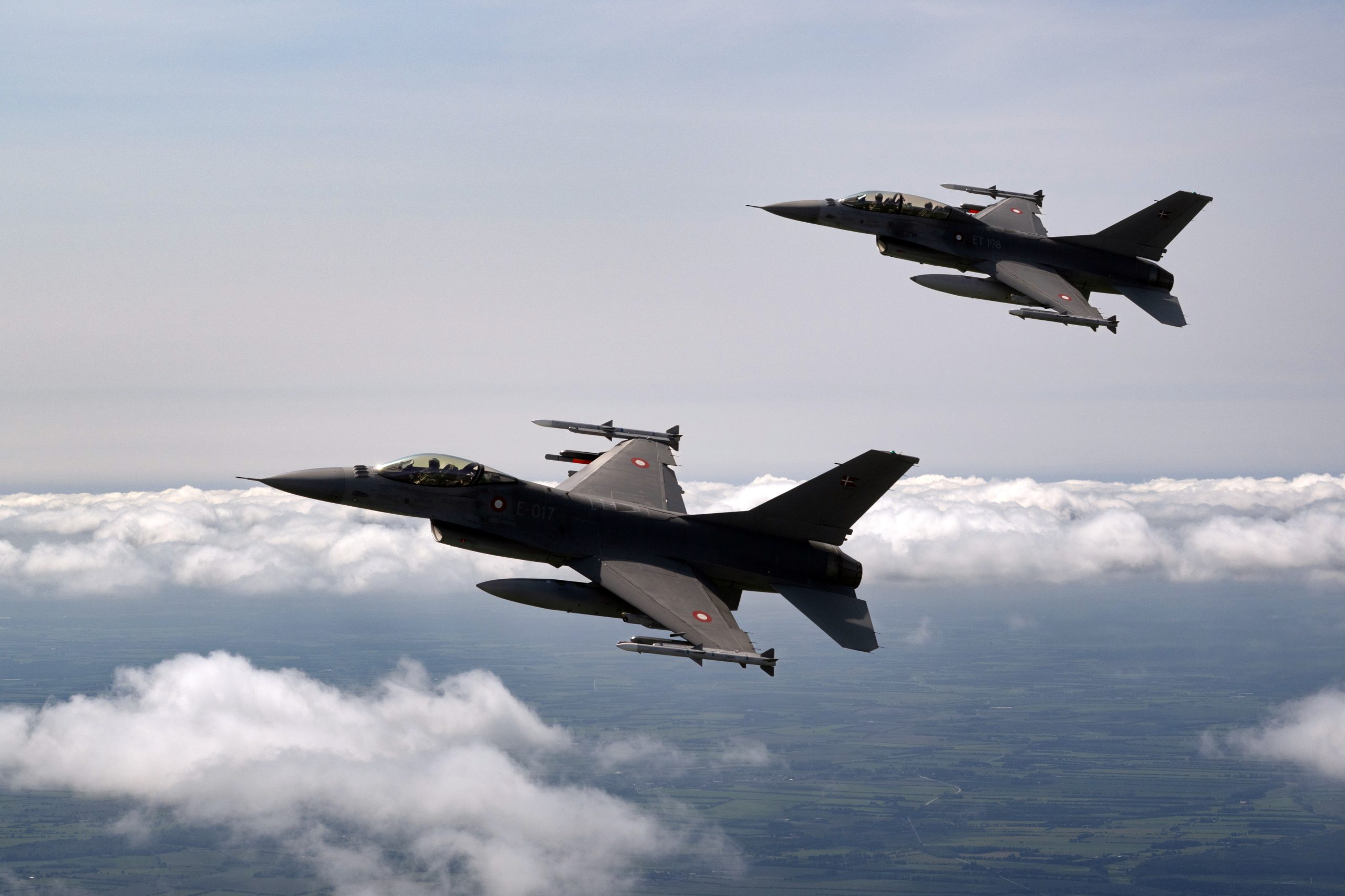 Royal Danish Air Force F-16AM Fighting Falcon pair in formation above cloud
