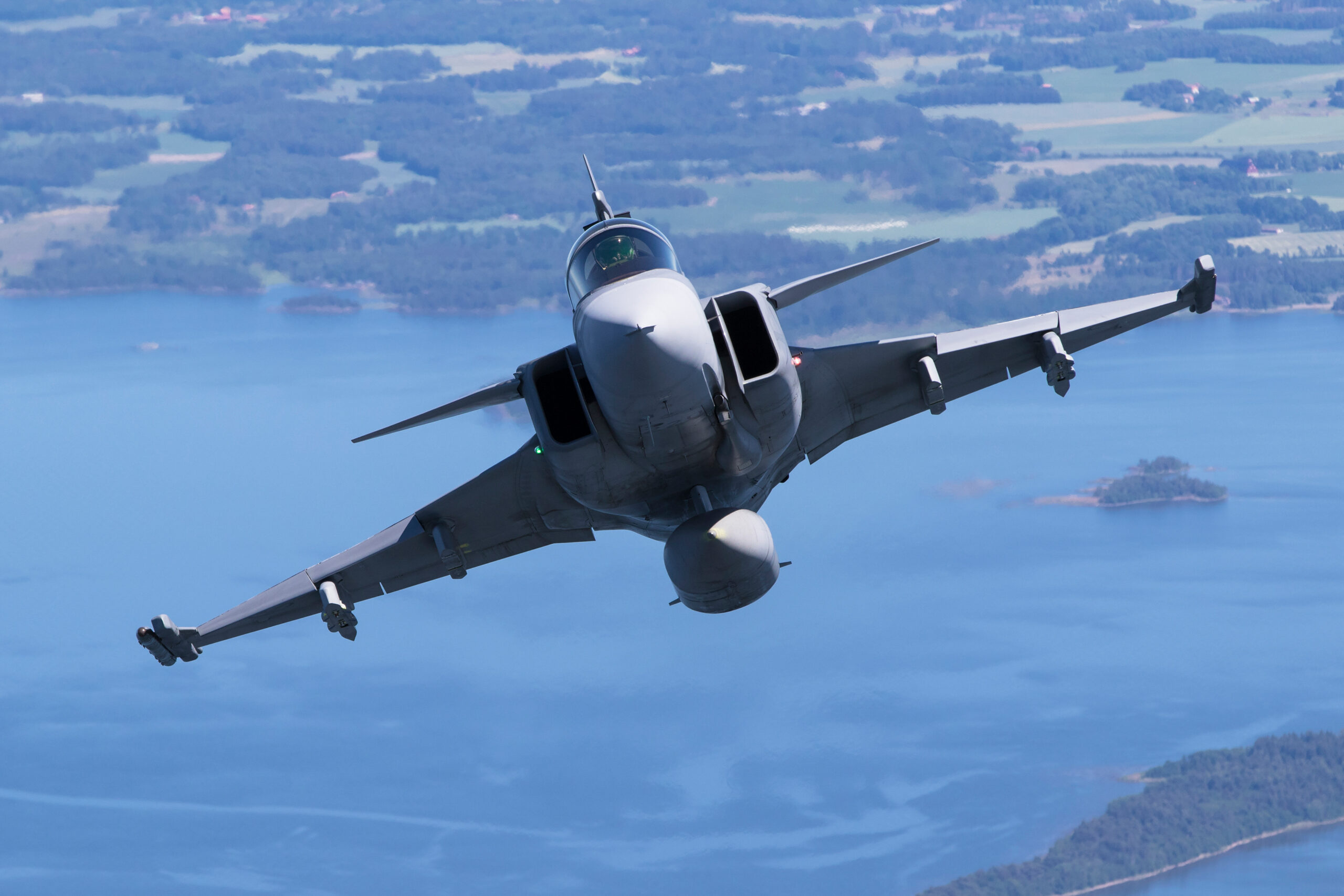 Saab JAS-39C Gripen fighter in a high-speed manoeuvre over the Swedish coast