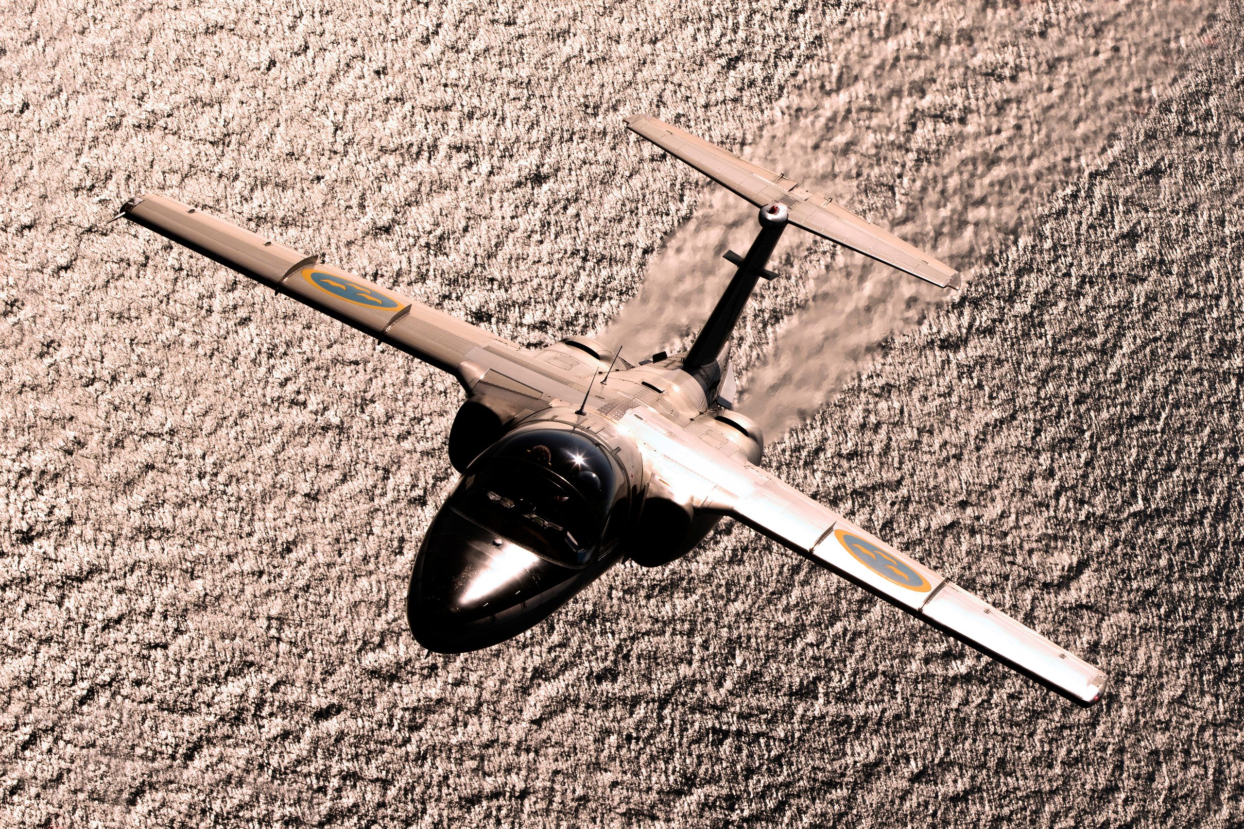 Saab SK 60B banking sharply as a toned silhouette