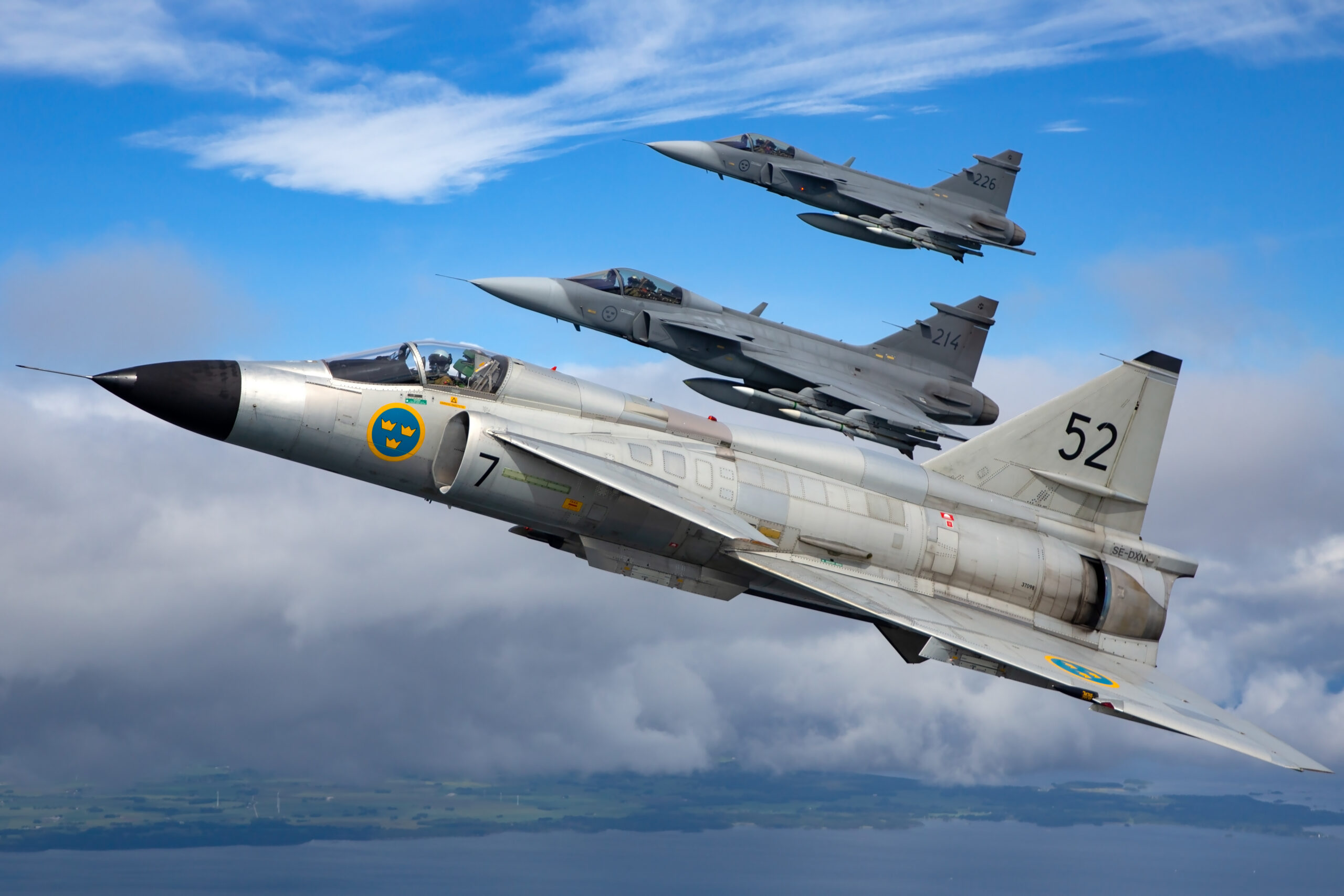 Saab AJS37 Viggen leading Gripens in formation over Sweden