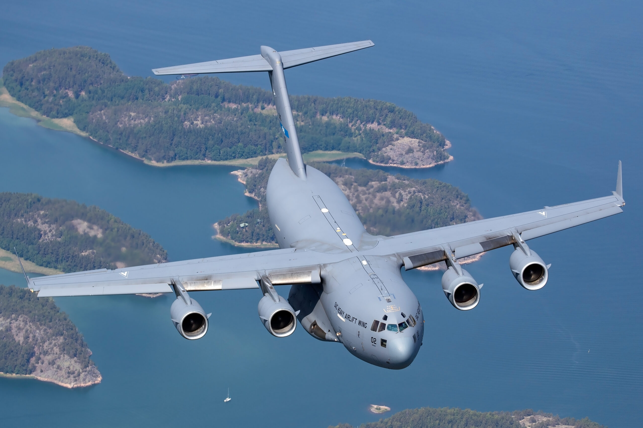 SAC Heavy Airlift Wing C-17A head-on over wooded islands