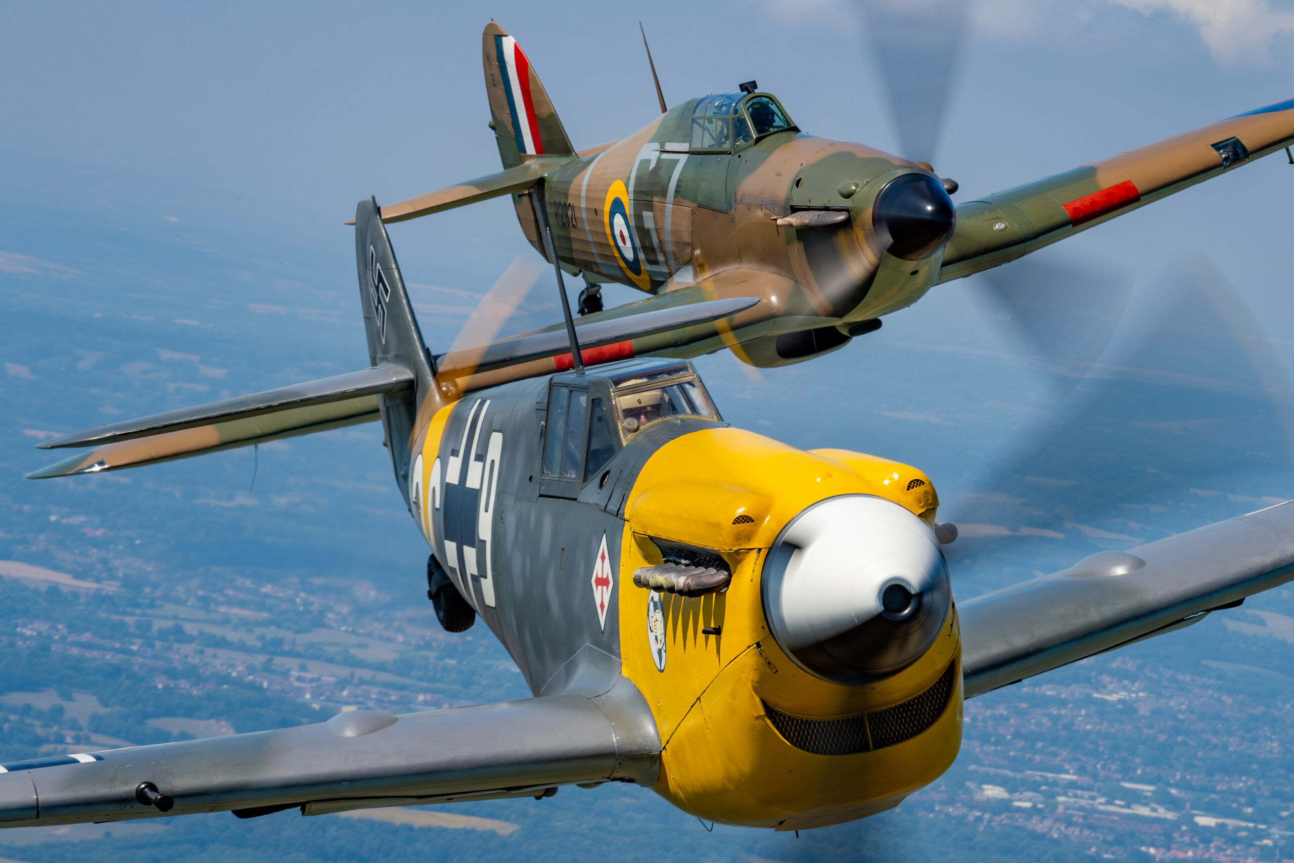 Hawker Sea Hurricane in formation with a yellow-nosed Hispano HA-1112 Buchon air to air