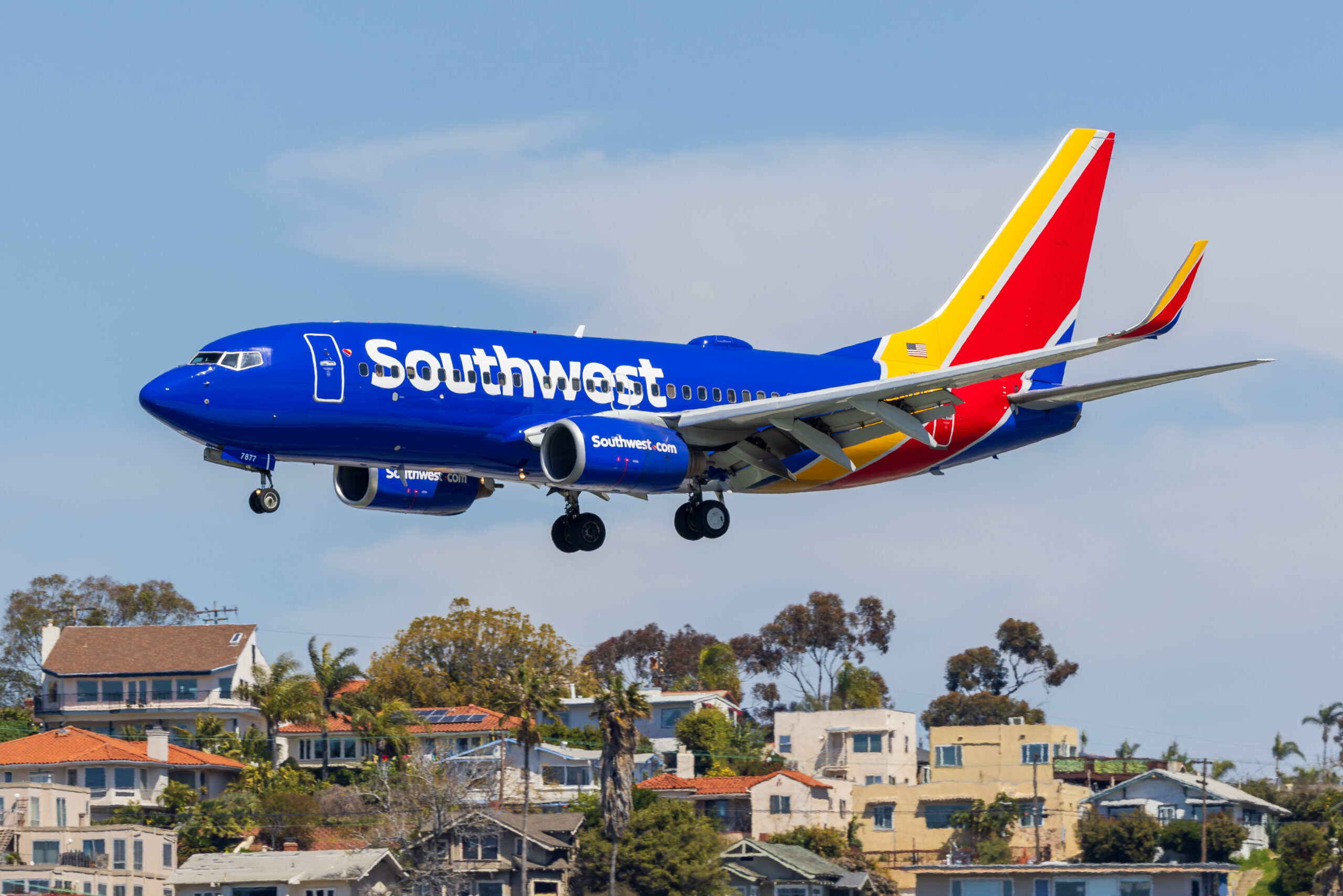 Southwest Airlines Boeing 737 N7877H on final approach over houses at San Diego