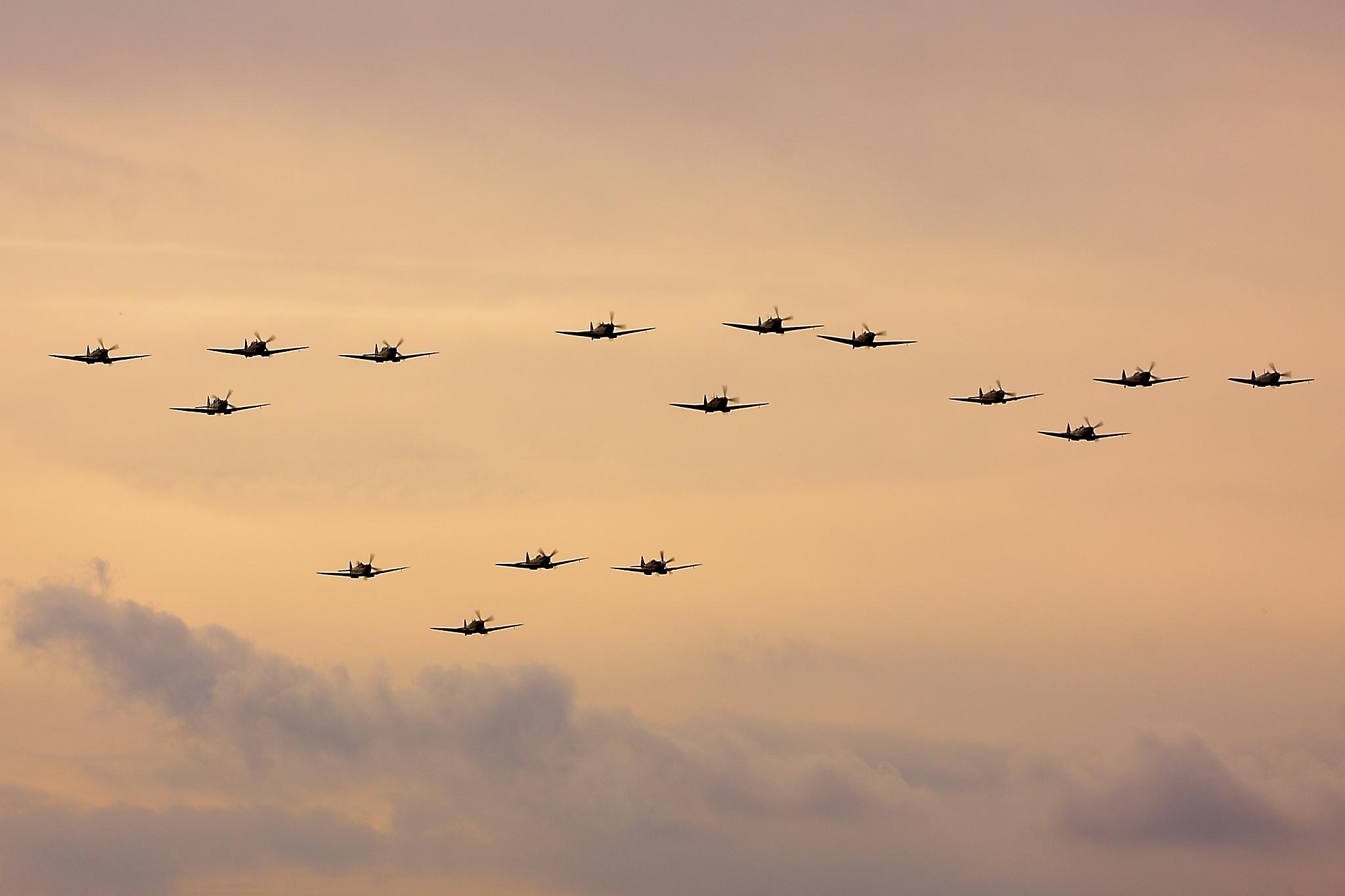 Spitfires flying in formation at Duxford with blurred propellers
