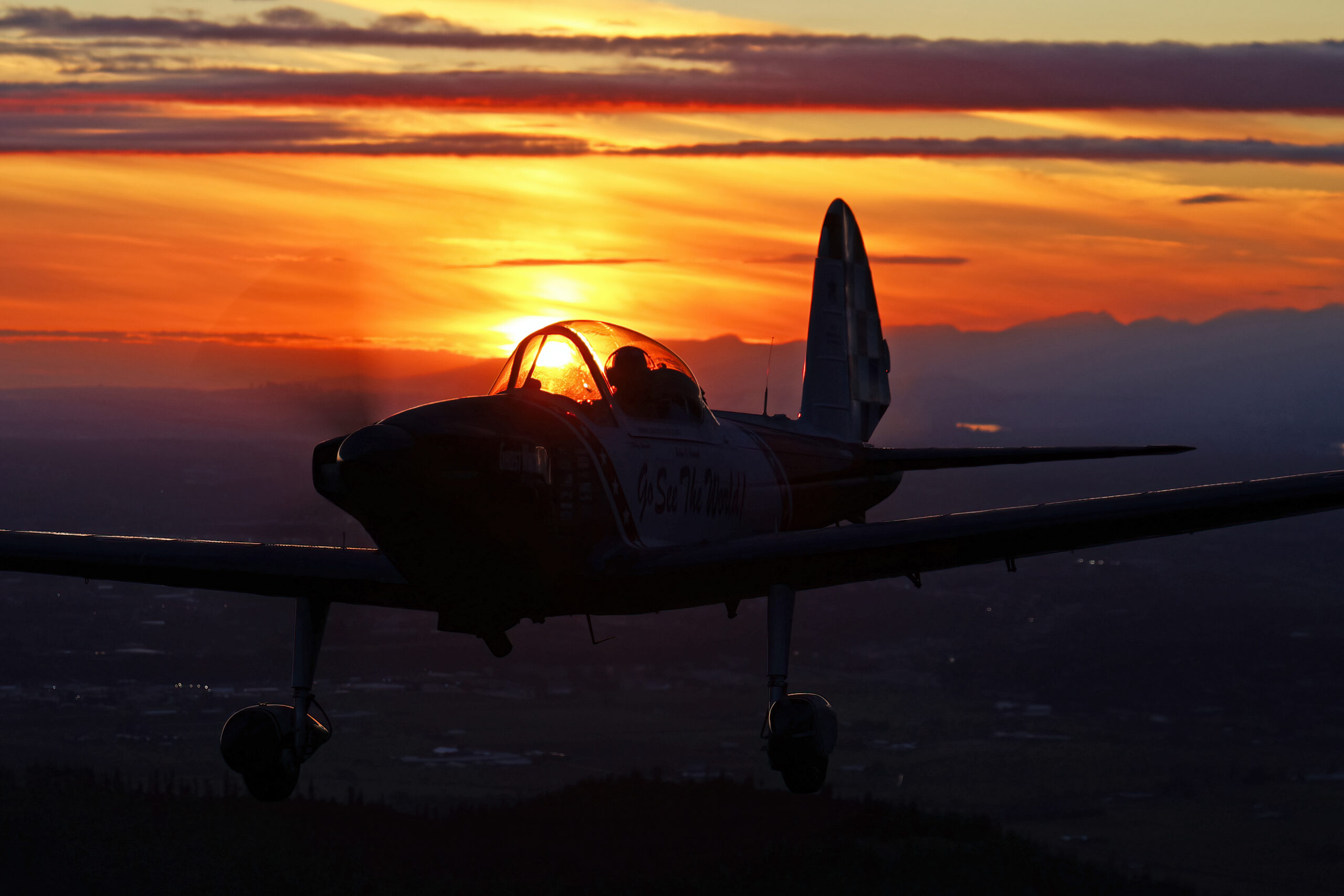 Super Chipmunk silhouetted against fiery sunset cloud layers