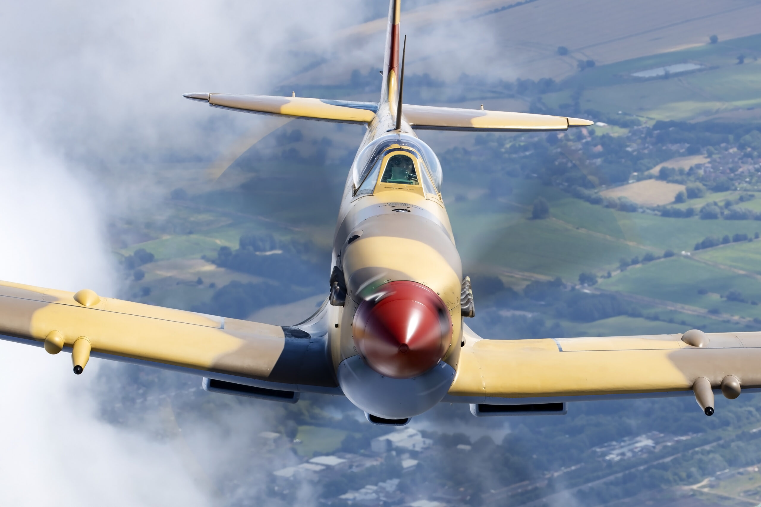 Head-on view of a desert-camouflaged Supermarine Spitfire Mk IX in flight