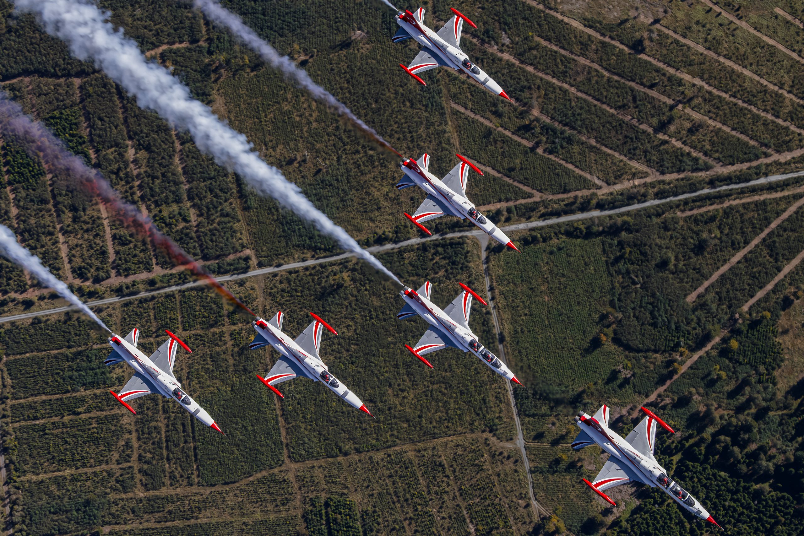 Turkish Stars NF-5 jets in formation trailing red and white smoke