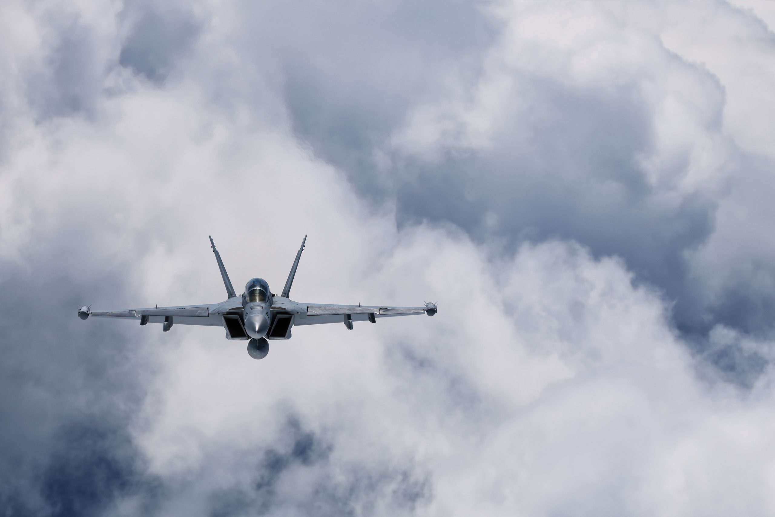 US Navy EA-18G Growler head-on among cloud, air to air