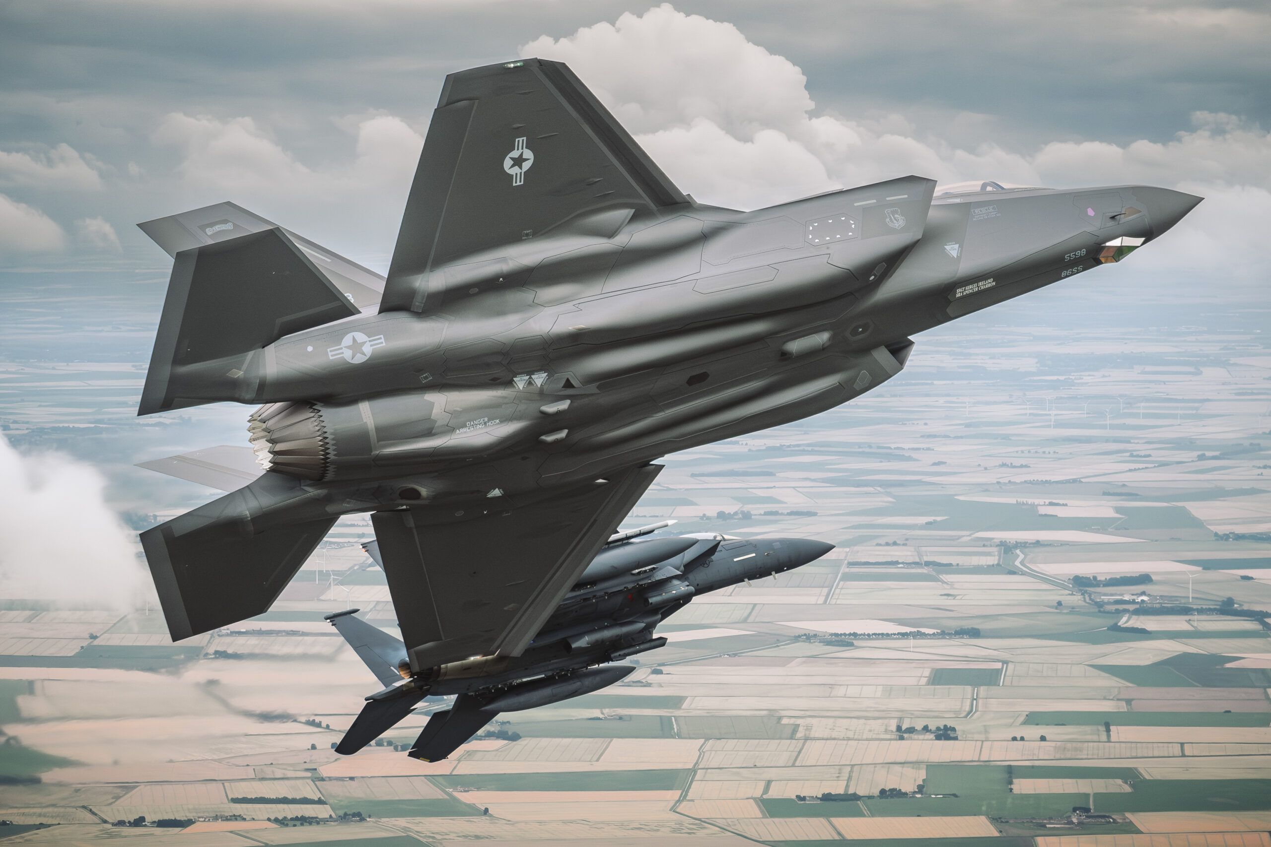 USAF F-35A 20-5598 banking with an F-15E Strike Eagle visible below