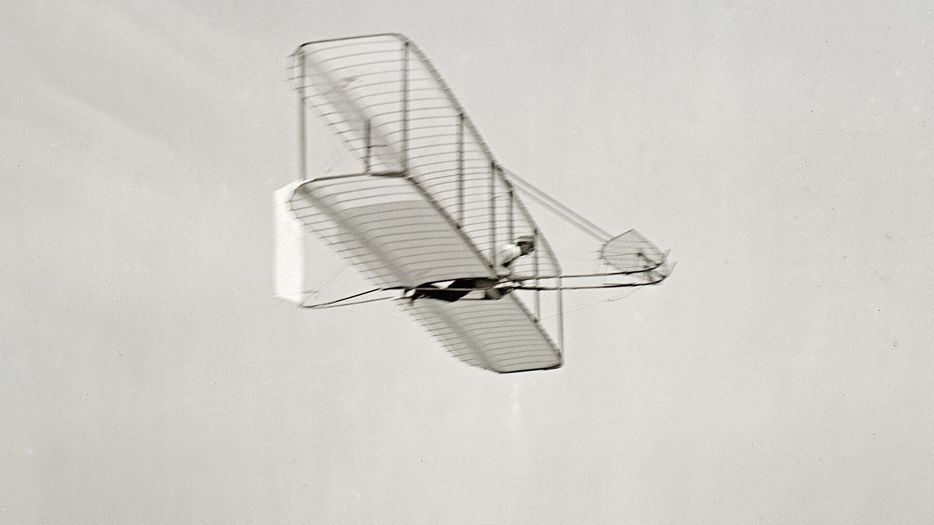 Wilbur Wright flying the 1902 Wright glider at Kitty Hawk