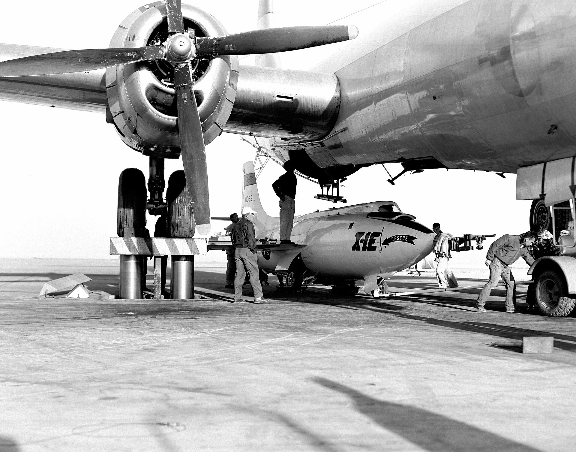 X-1E research aircraft loaded under its B-29 mothership on the ramp