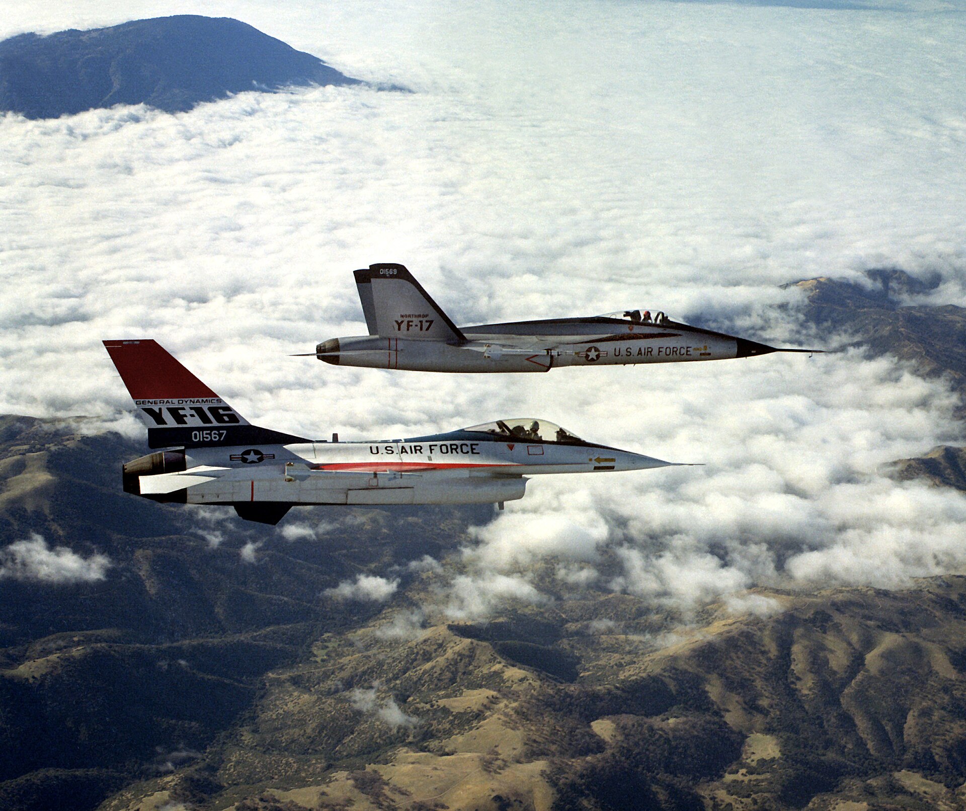 YF-16 and Northrop YF-17 prototypes flying side by side, armed with AIM-9 Sidewinder missiles