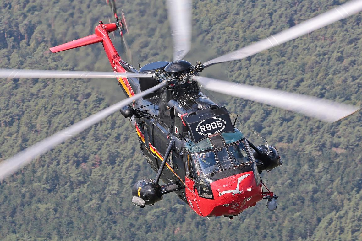 Belgian Air Force Westland Sea King Mk48 RS05 in red and black scheme over forest, air to air
