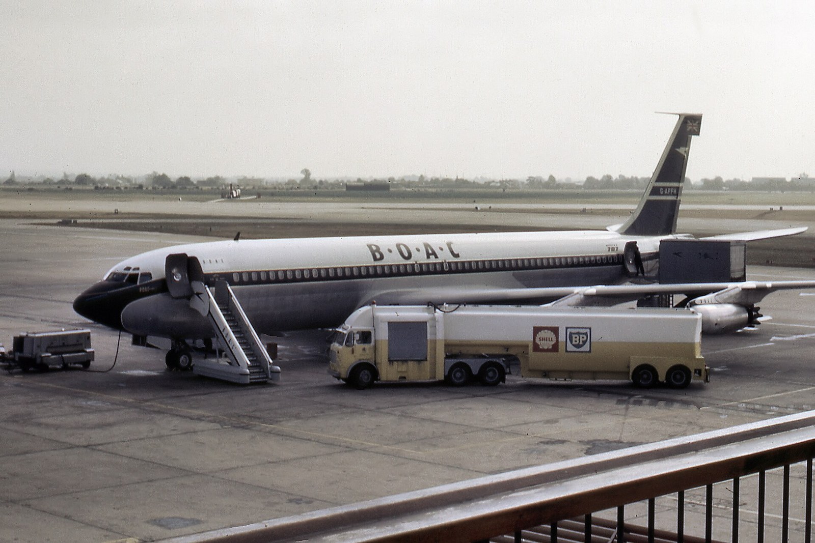 BOAC Boeing 707-436 on the apron at London Airport in 1964 with a fuel bowser alongside