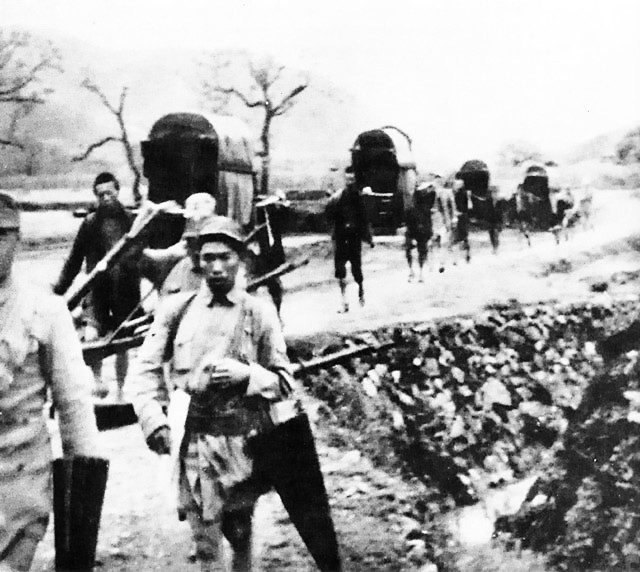 Chinese rescuers carry Doolittle Raiders to safety by sedan chair, April 1942