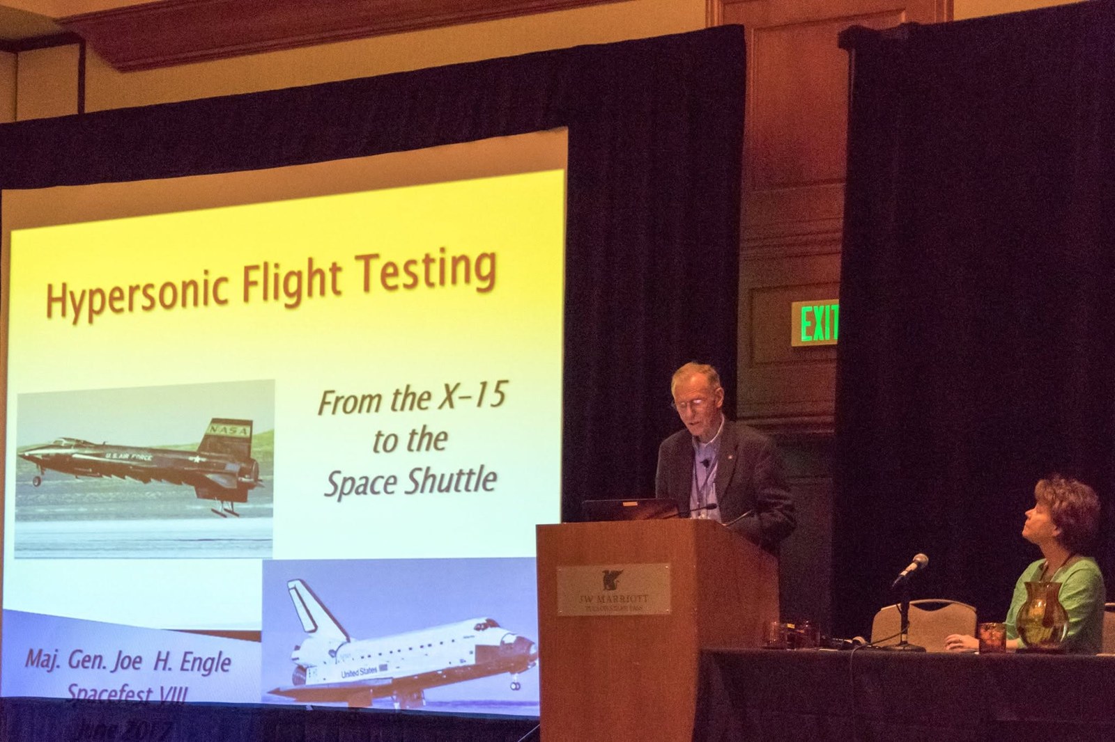 Joe Engle speaking at Spacefest VIII in Tucson in June 2017, beside a slide titled Hypersonic Flight Testing: From the X-15 to the Space Shuttle