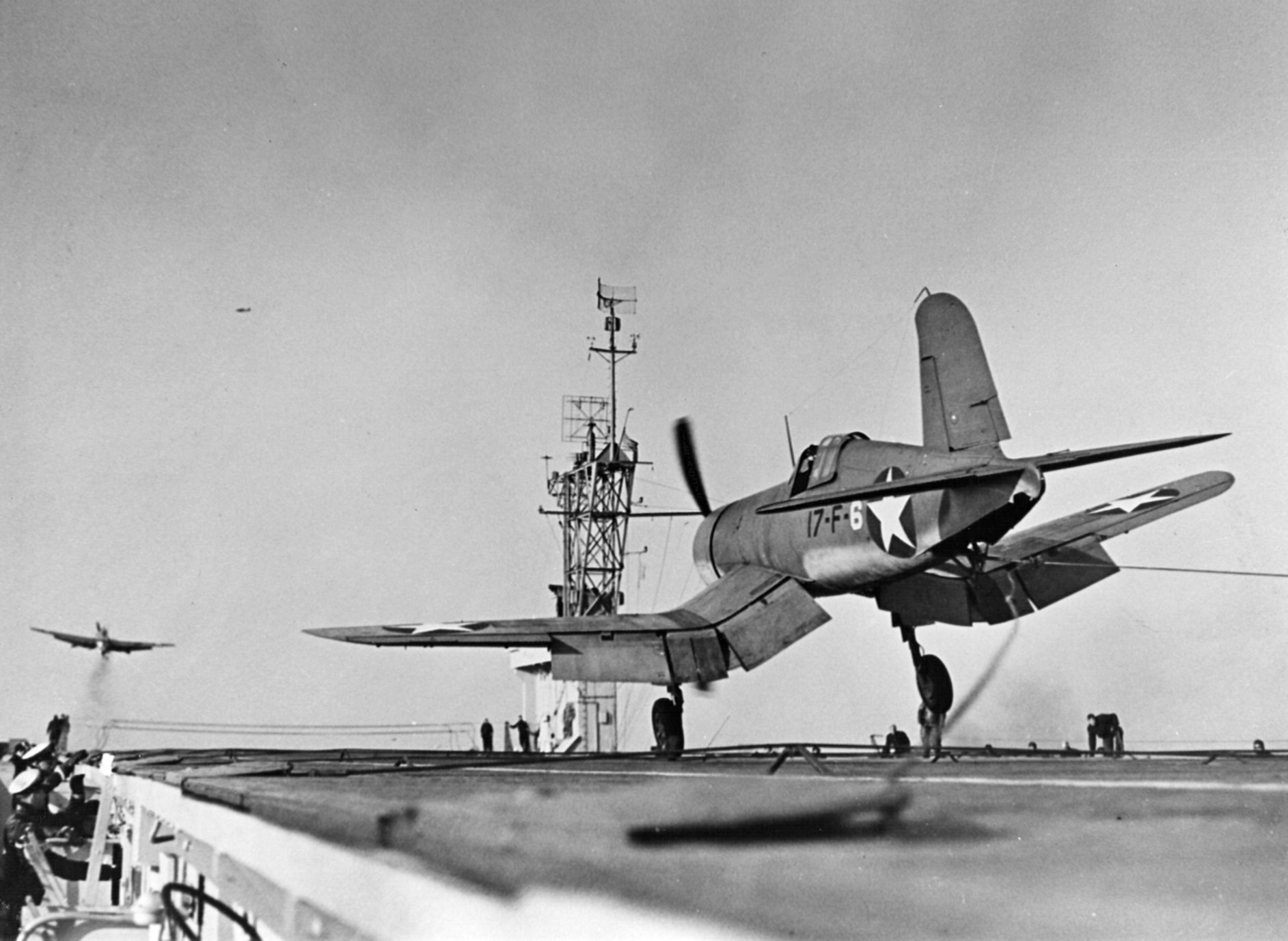 A birdcage F4U-1 Corsair of VF-17 landing aboard USS Charger during 1943 carrier trials