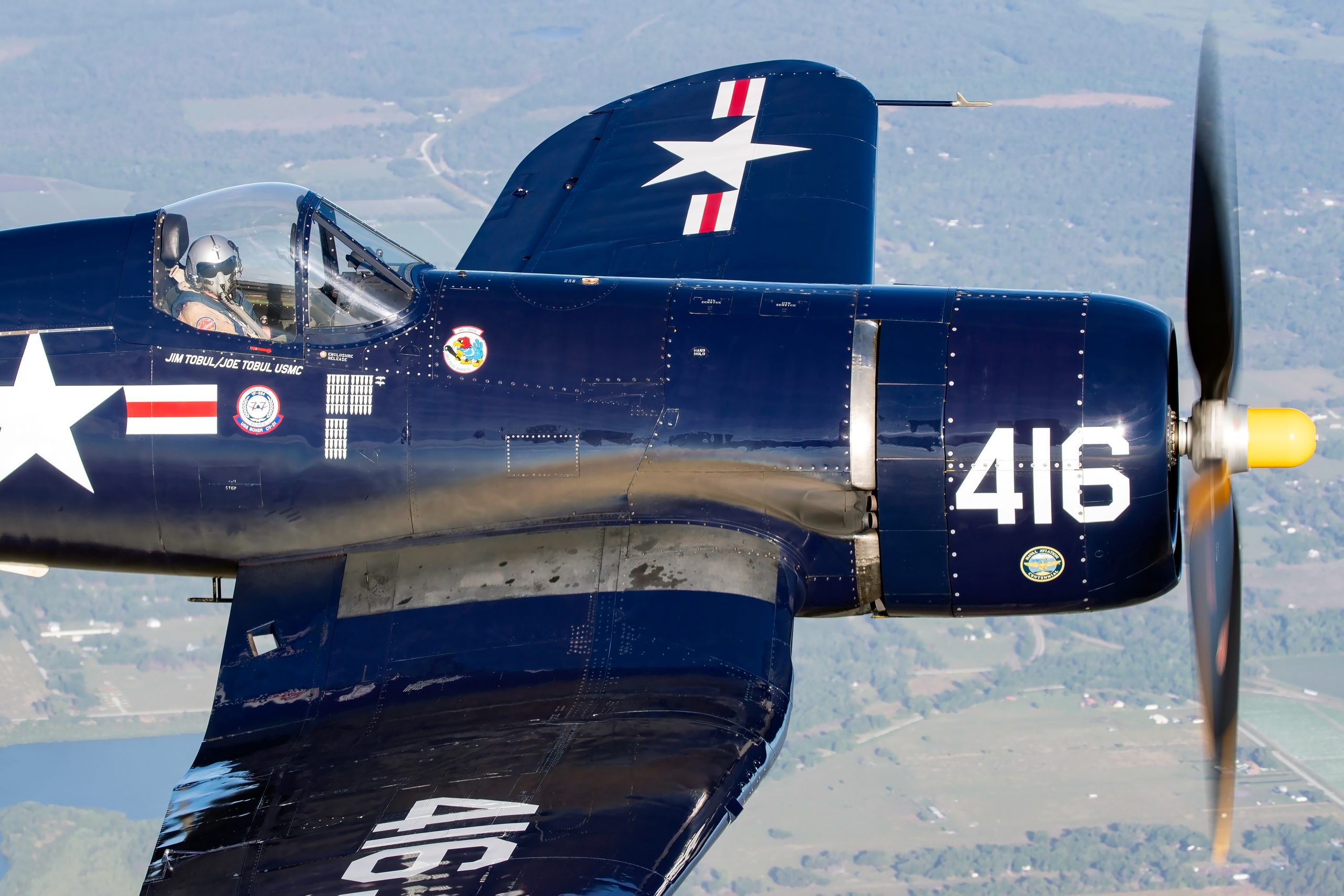 Vought F4U-4 Corsair close up rear quarter showing tail and star and bar markings, air to air