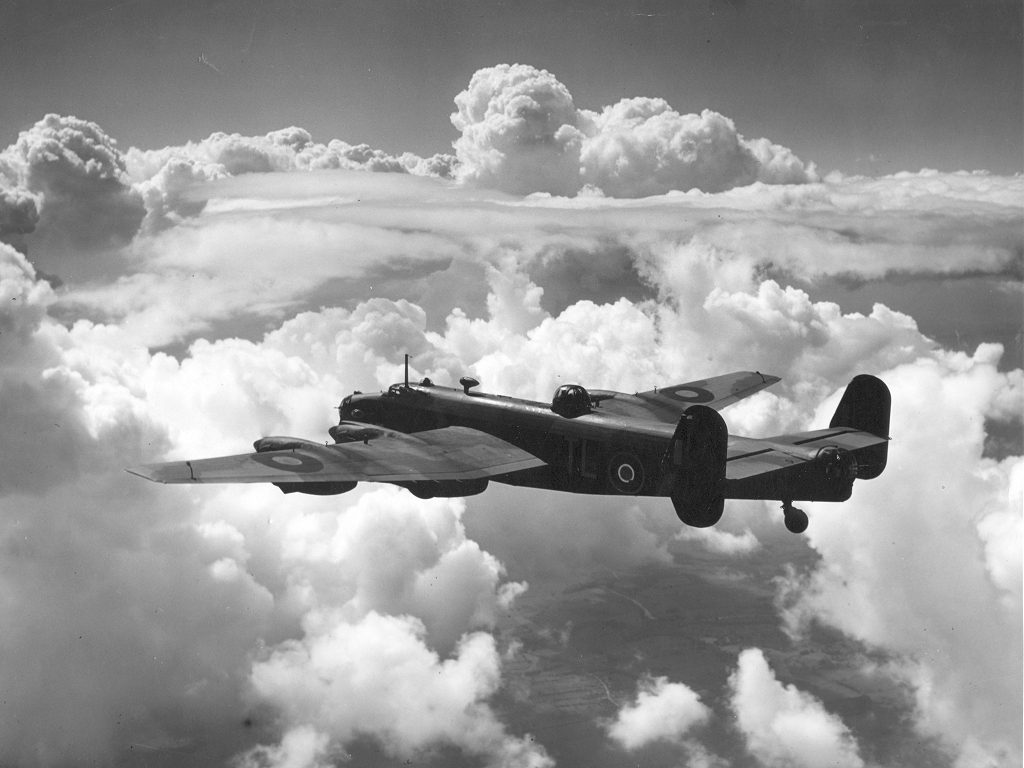 Handley Page Halifax Mk III in flight among towering clouds