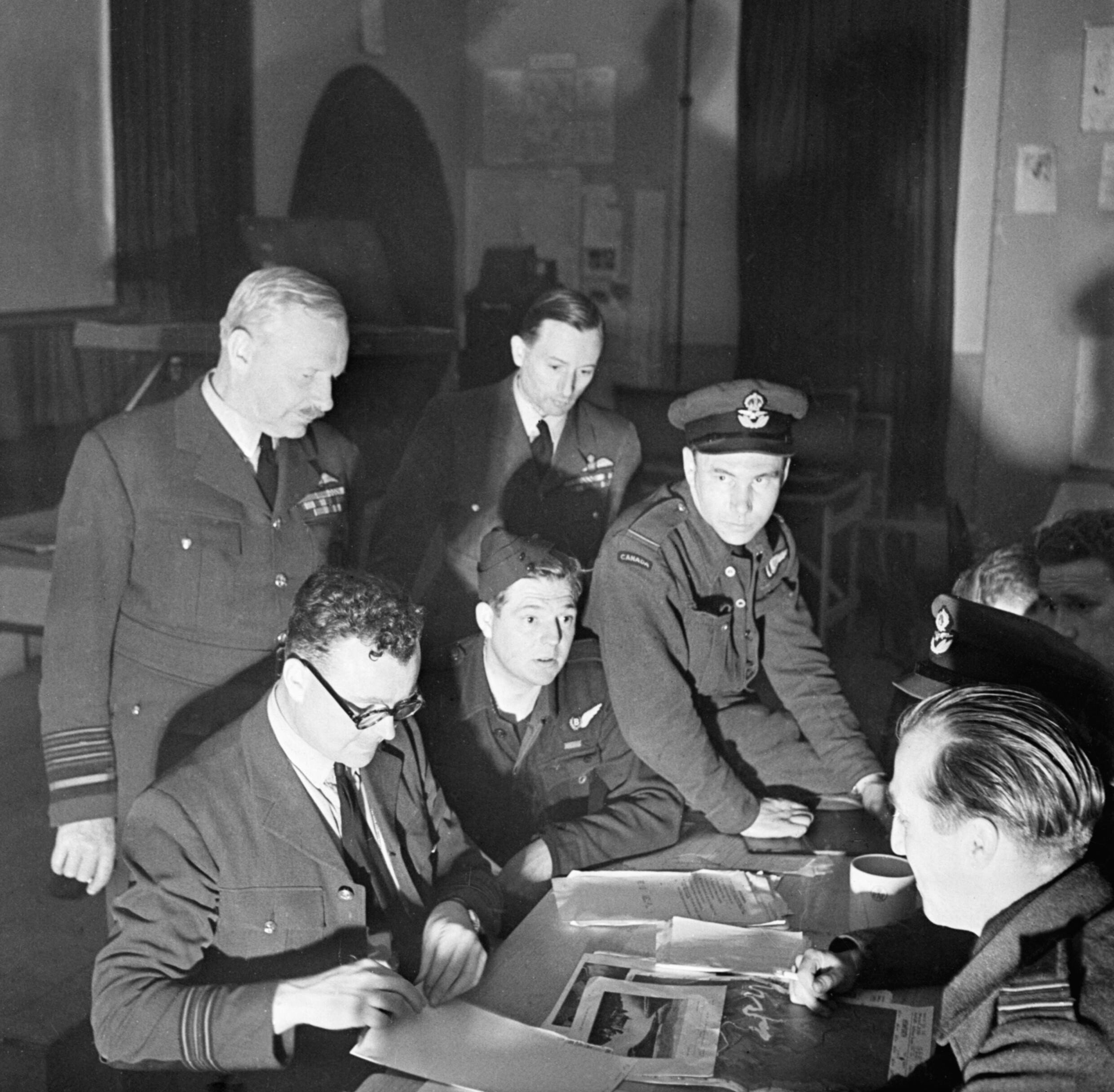 Arthur Harris observes as Gibson's crew is debriefed on the morning after the raid