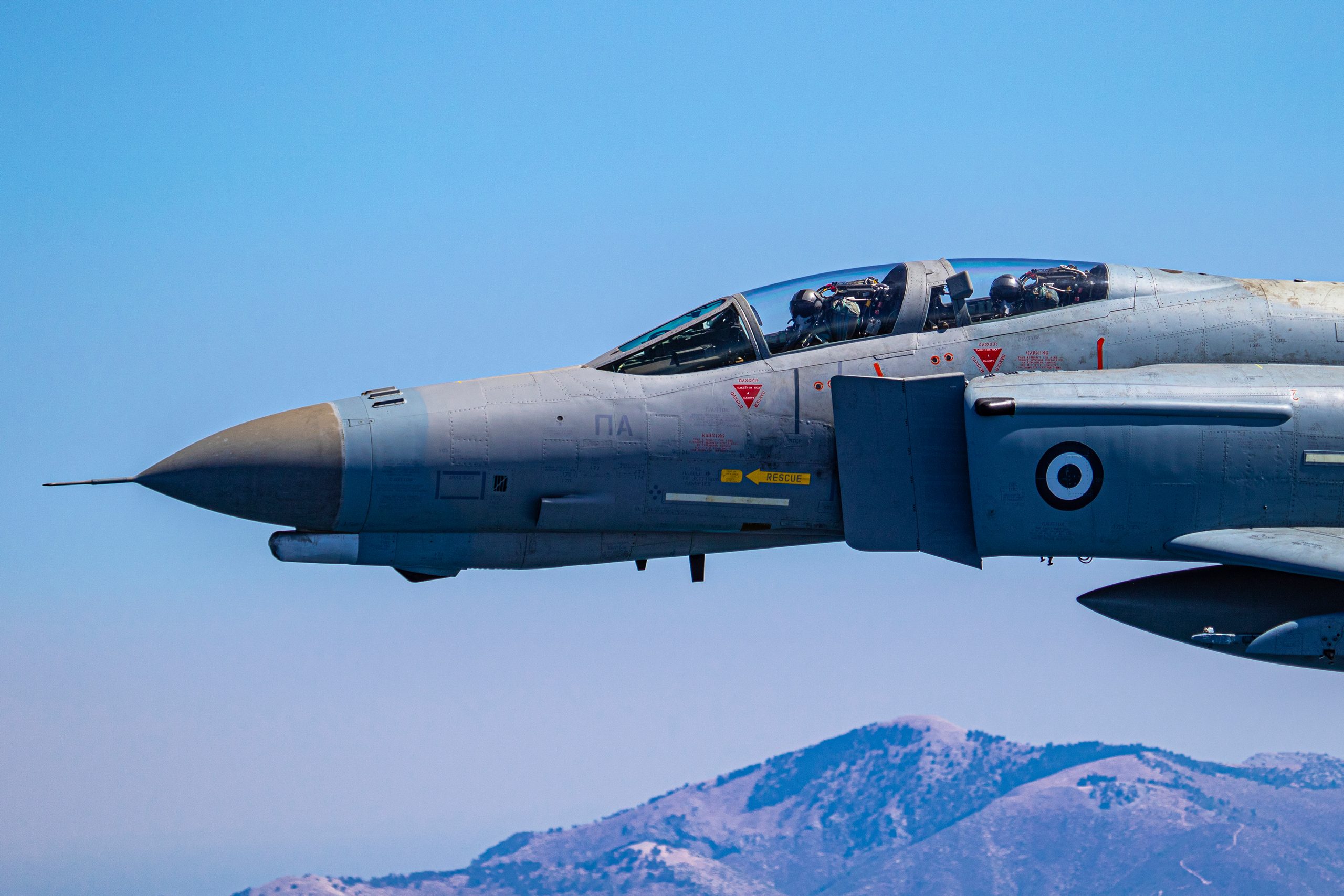 Close up of Hellenic Air Force F-4E AUP Phantom II 01518 showing both crew members, air to air