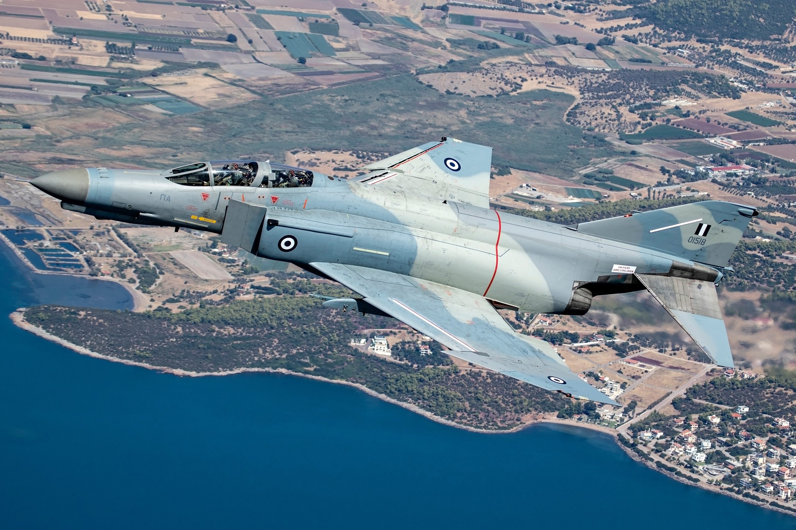 Hellenic Air Force F-4E AUP Phantom II 01518 over the Greek coastline showing its camouflage topsides, air to air