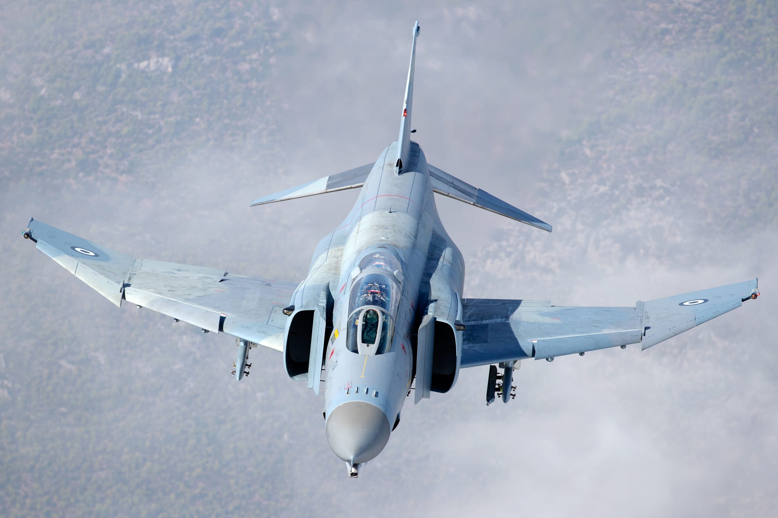 Hellenic F-4E AUP Phantom II 01518 with gear down climbing through cloud, air to air