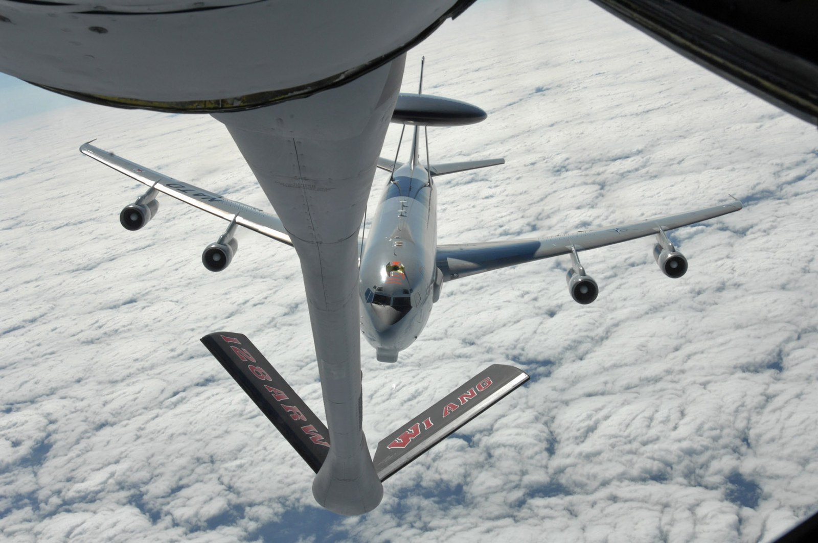 KC-135 Stratotanker refuelling boom extended towards a Boeing E-3 Sentry in flight