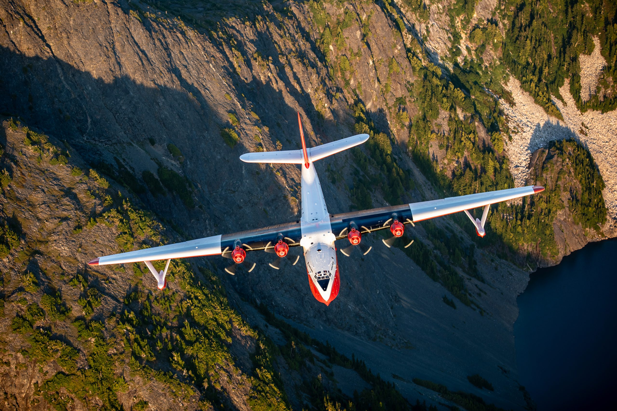 Martin JRM Hawaii Mars head on against forested cliffs, air to air