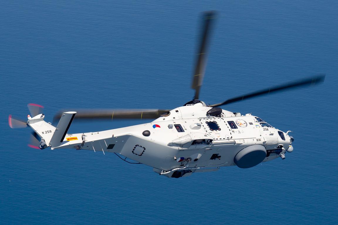 NH90 NFH naval helicopter over open sea, air to air