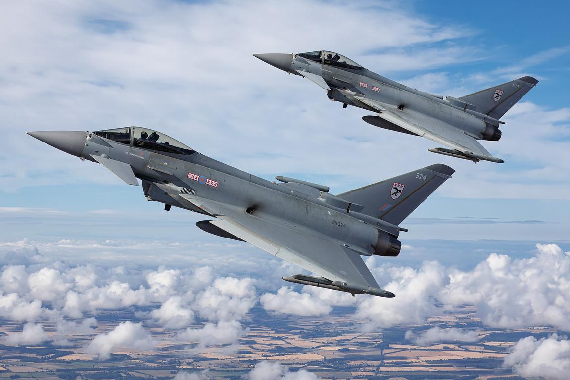 Two RAF Typhoon FGR4s banking together above cloud, air to air
