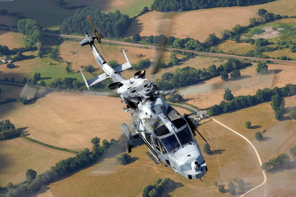 Royal Navy AW159 Wildcat over patchwork fields, air to air