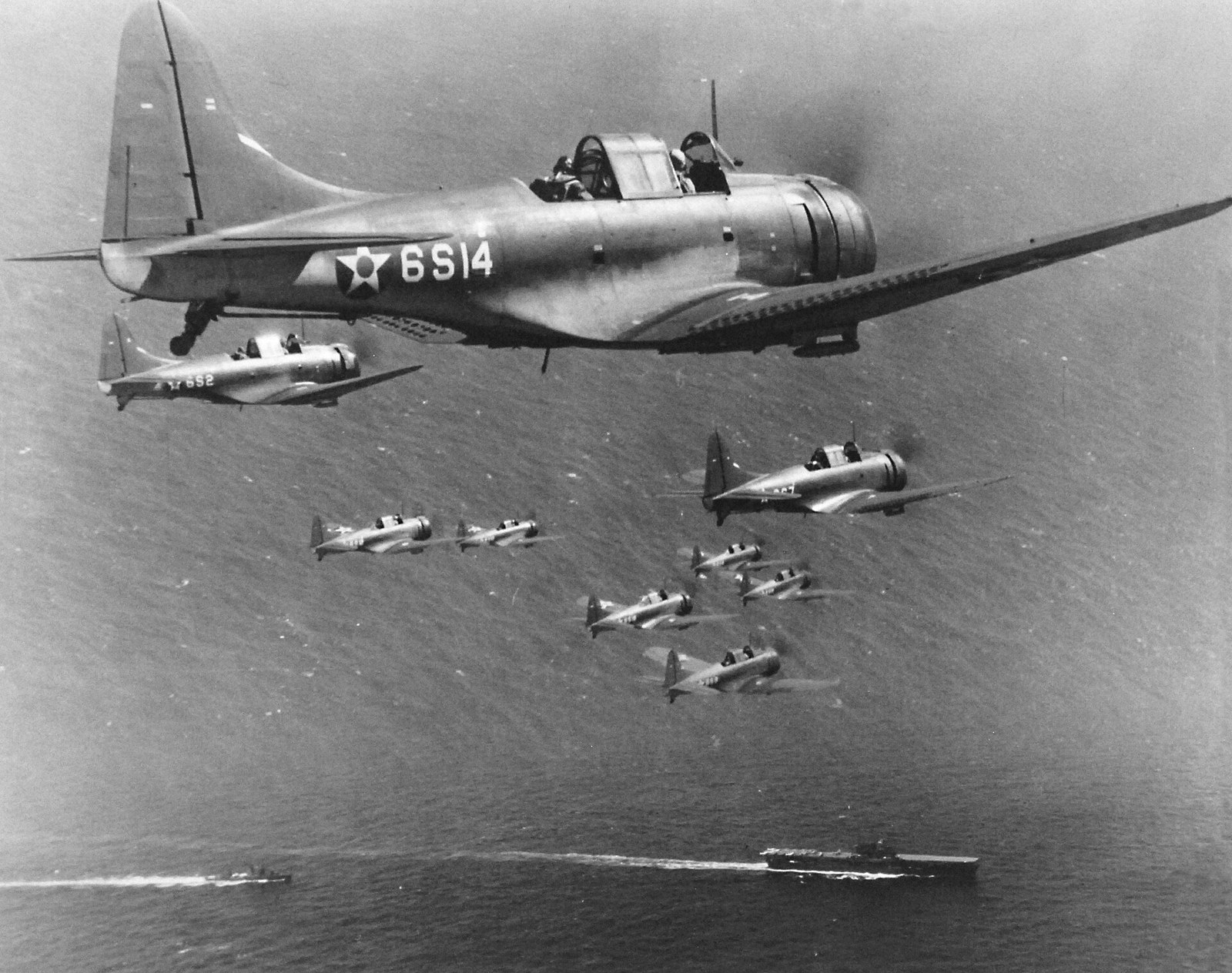 Formation of Douglas SBD Dauntless scout bombers of Scouting Six flying above USS Enterprise