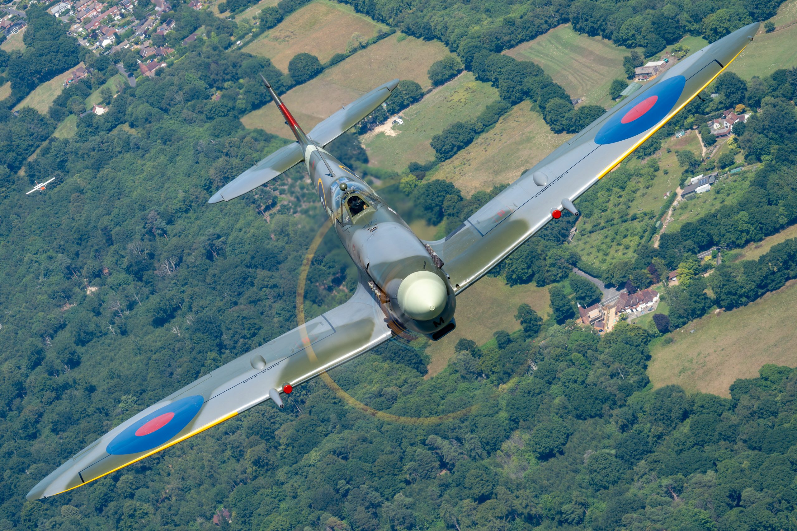 Supermarine Spitfire HF IXe photographed head-on over wooded countryside