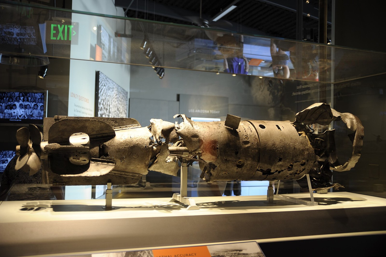 Recovered Japanese Type 91 aerial torpedo displayed in a case at Pearl Harbor
