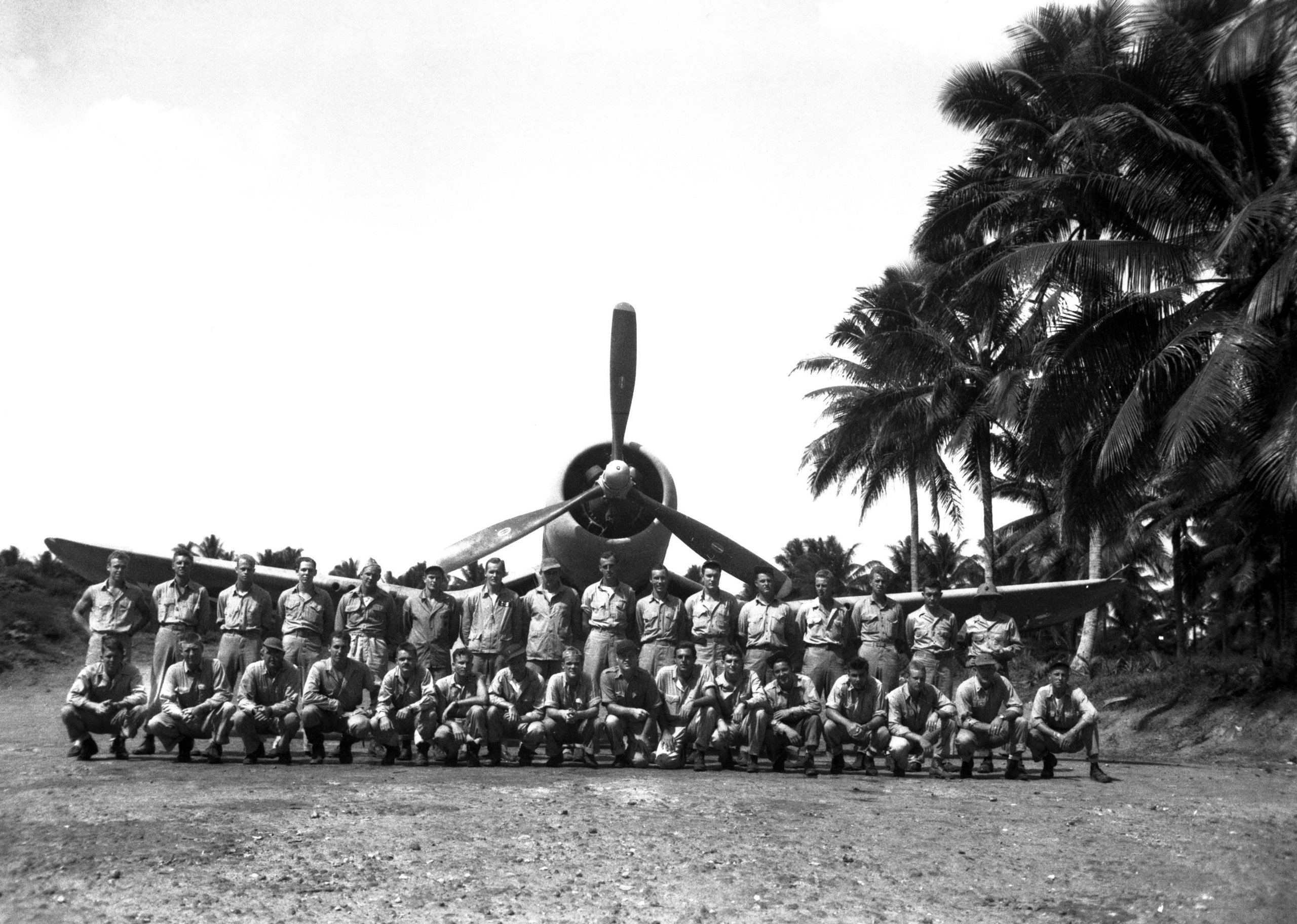 Pilots of Marine squadron VMF-214, the Black Sheep, posing on a Corsair at Espiritu Santo