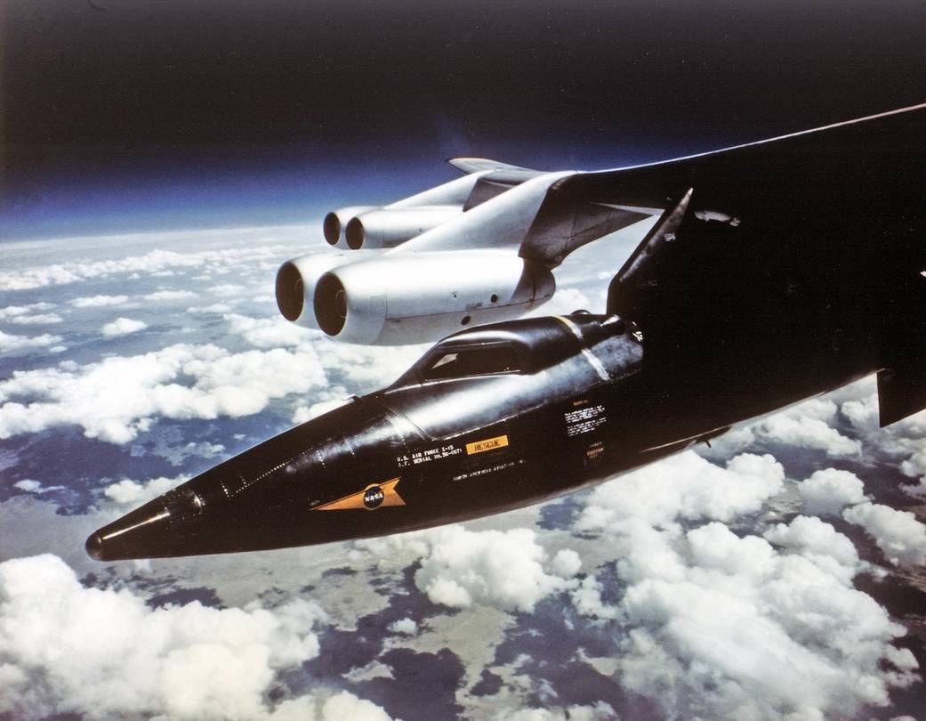An X-15 mated beneath the wing of its NB-52 carrier aircraft before a research flight