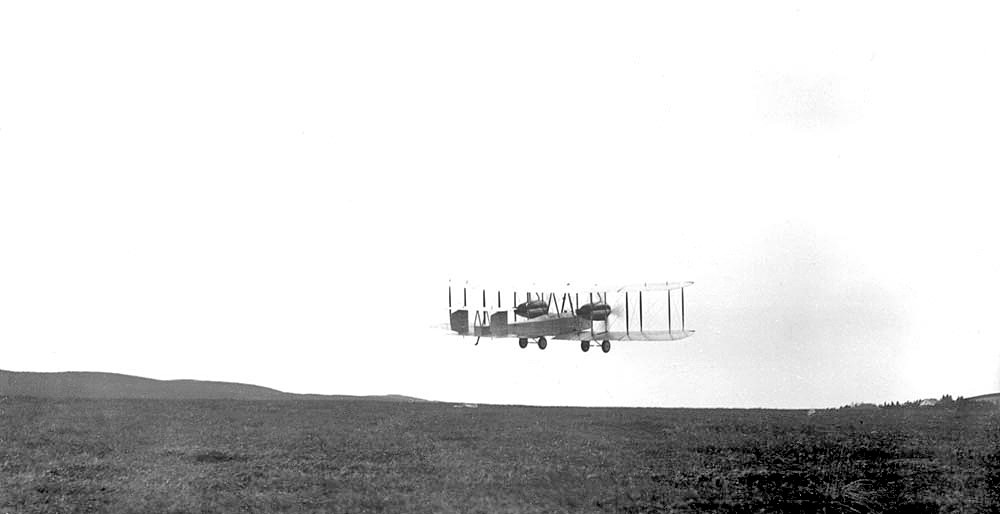 The Vickers Vimy photographed low over open ground outside St John's in June 1919