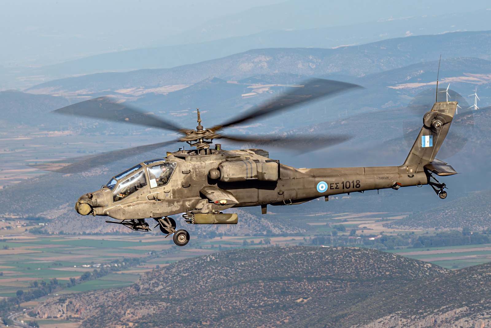 A McDonnell Douglas AH-64A Apache of the Hellenic Army in flight over Greece, with no mast-mounted radar above the rotor head