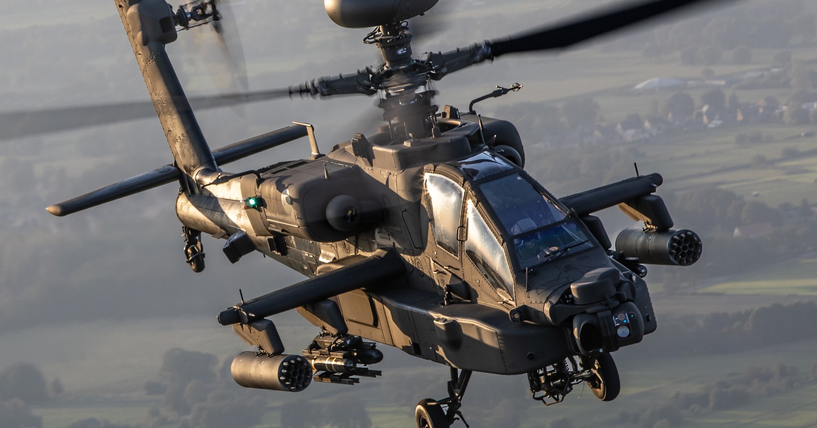 A Boeing AH-64E Apache Guardian of the Royal Netherlands Air Force in flight, the mast-mounted Longbow radar visible above the rotor head