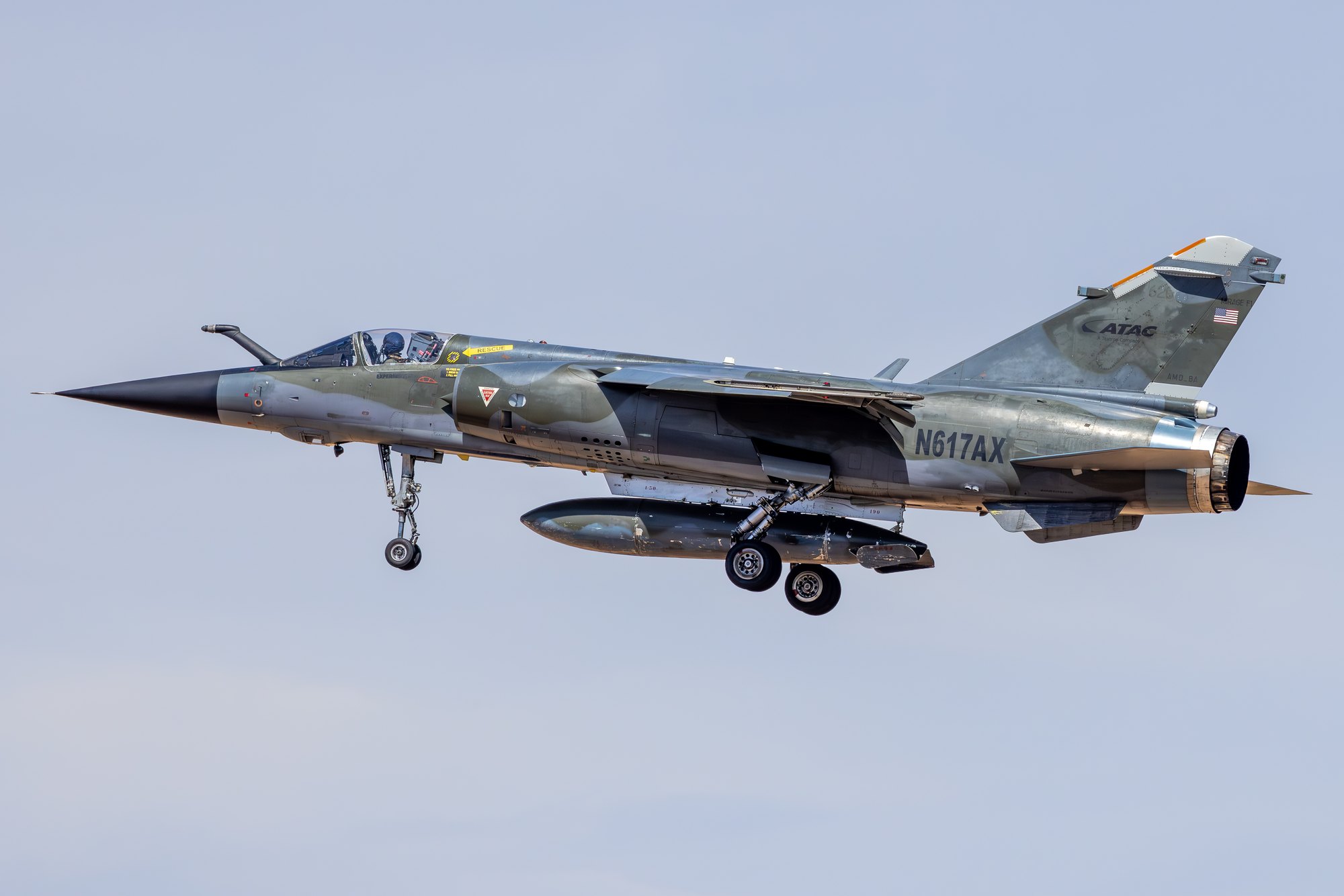 A Dassault Mirage F1CR in green and grey camouflage, US civil registration N617AX, operated by ATAC, on approach with gear down.
